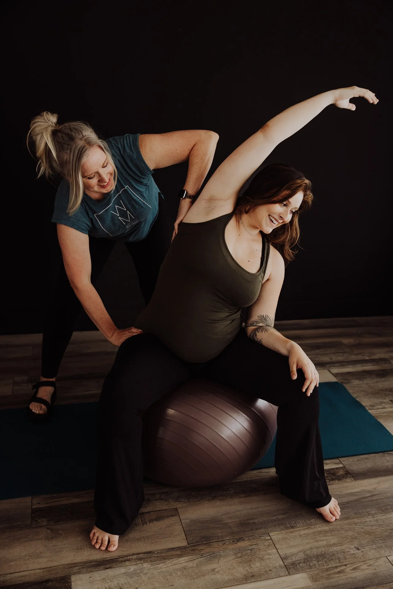 Janelle Kloske, OT and Sex Counselor, helping pregnant young woman with exercises with a yoga mat and excersise ball