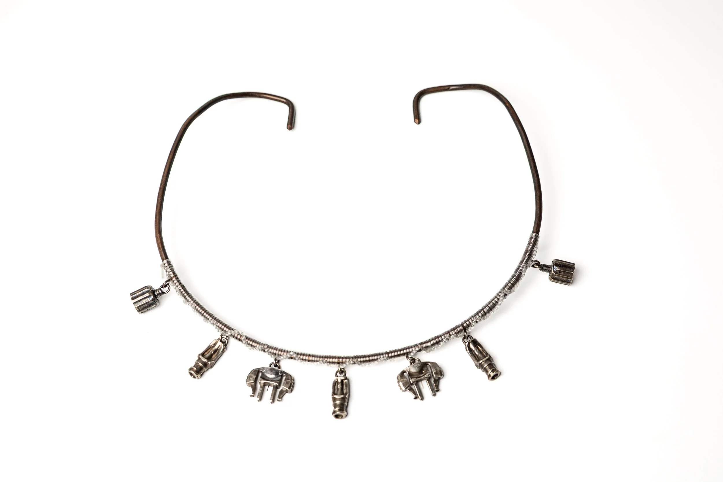 A silver necklace with tubing and infusion-shaped pendants hanging from it.