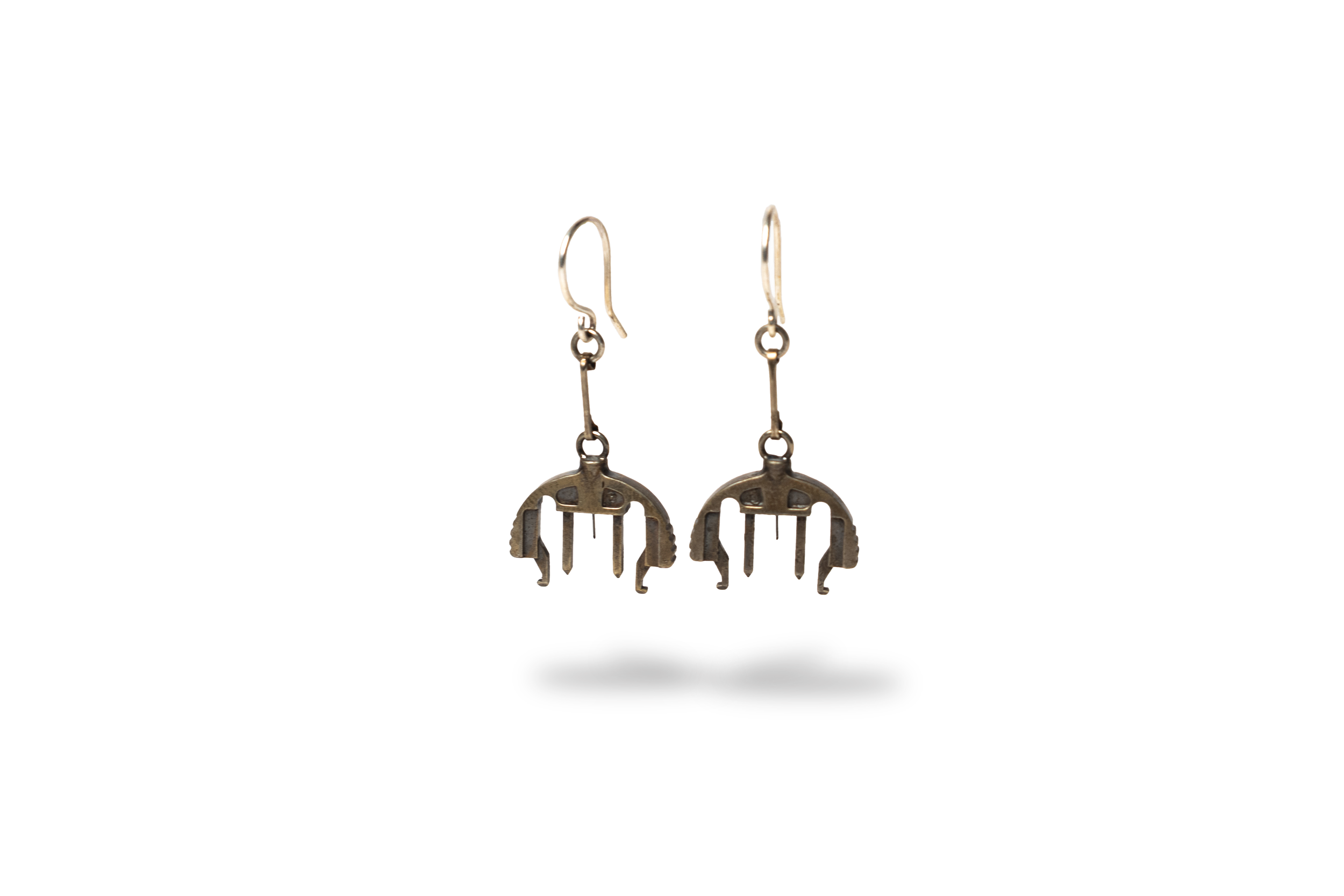 Bronze and silver earrings with infusion sets dangle design on a plain white background.