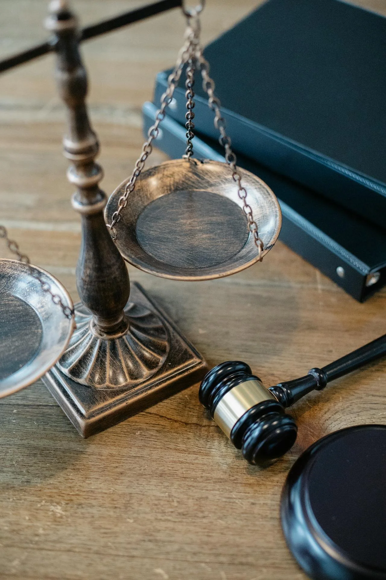 Scales of justice and a judge’s gavel on a desk, representing legal services at Diviney & Wilt