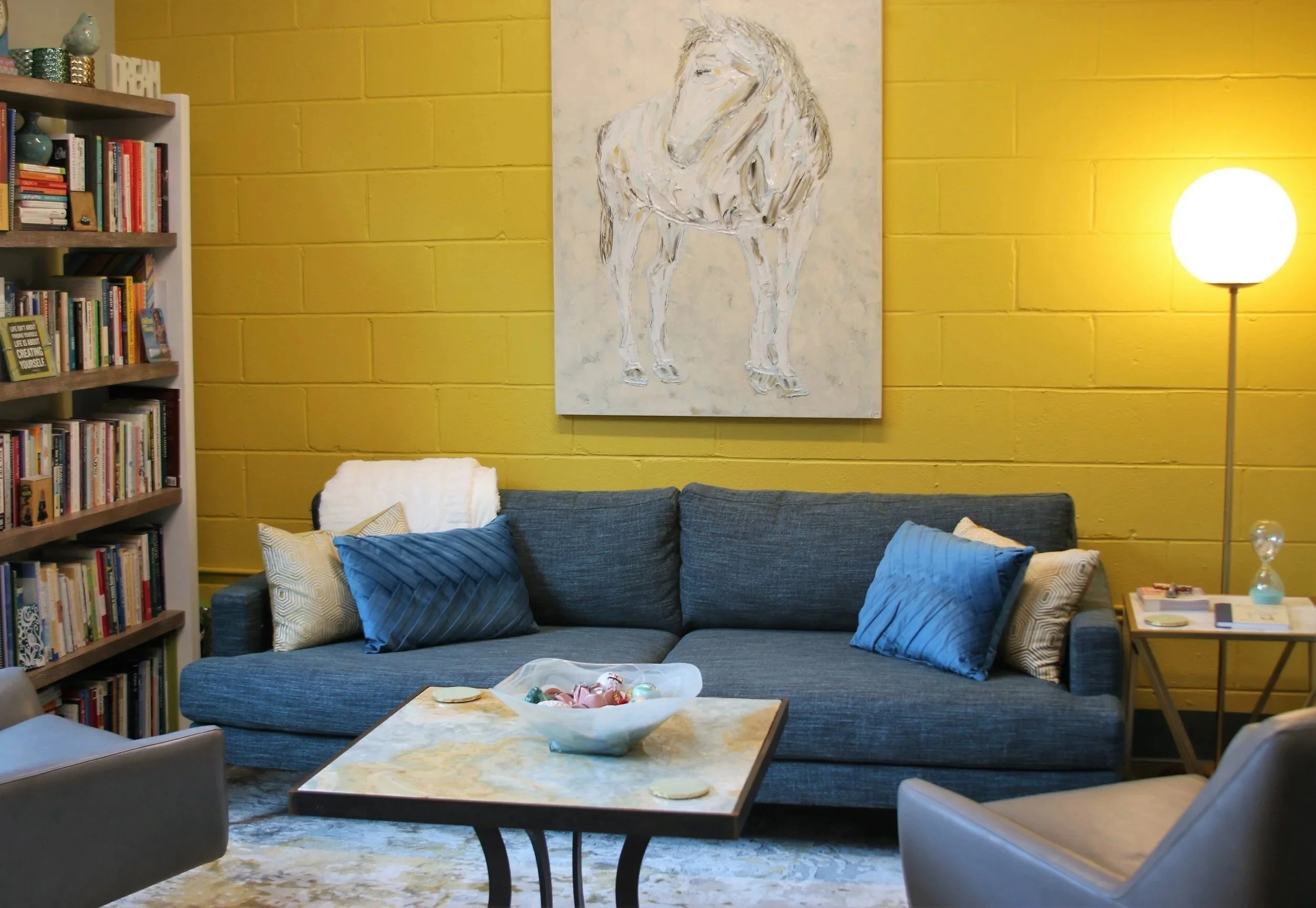blue couch, yellow background at Midtown Psychotherapy Associates