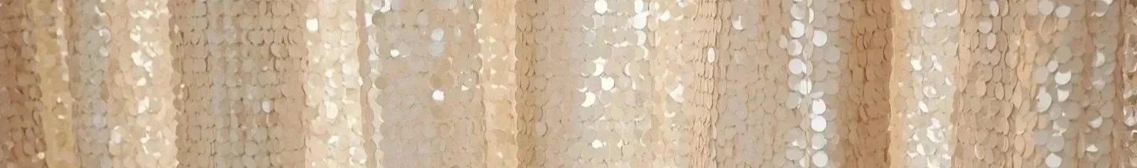 Close-up view of a textured curtain with a gold, metallic, and circular pattern.