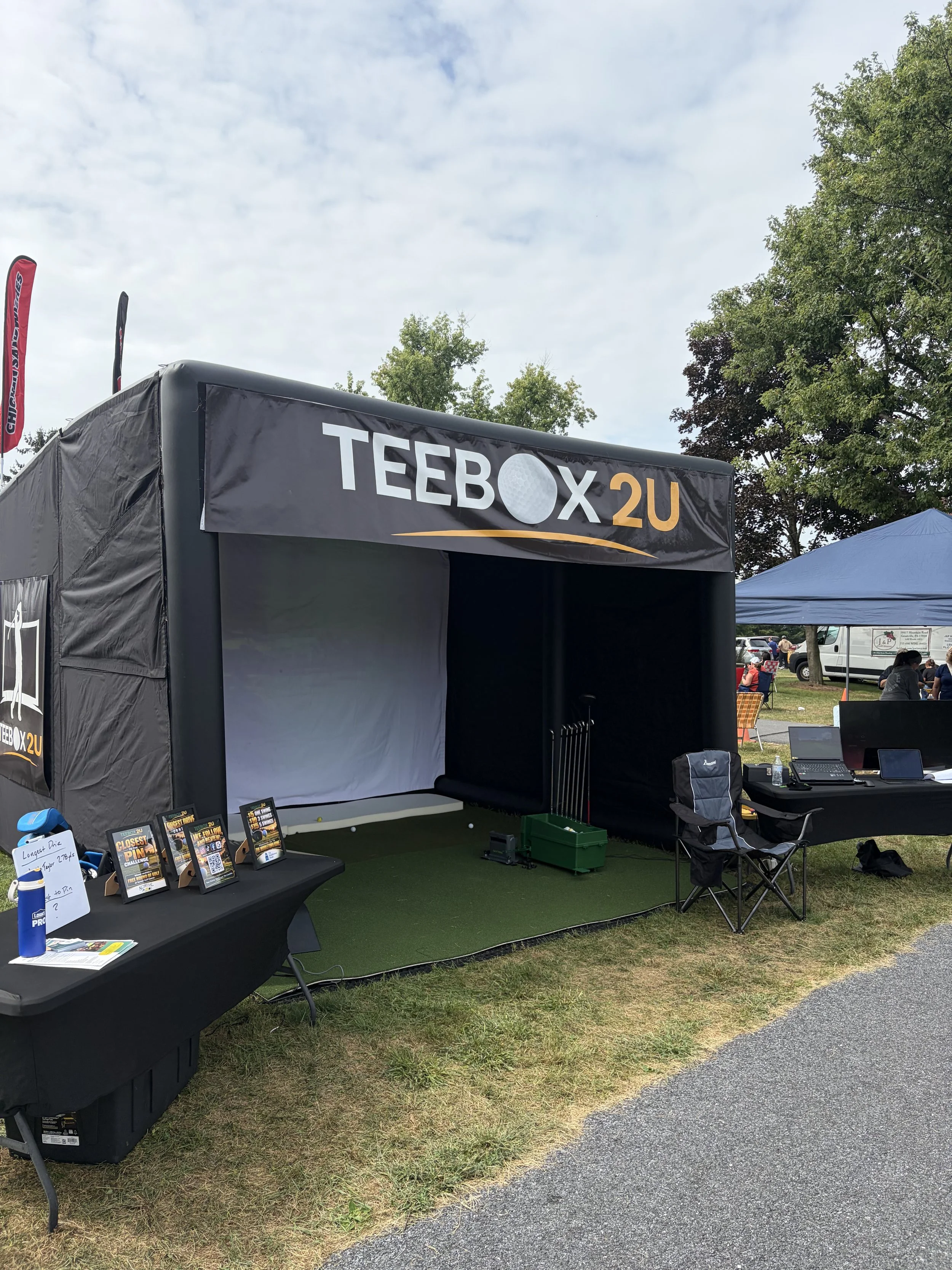 TeeBox2U inflatable golf simulator enclosure with a projection screen and hitting mat.