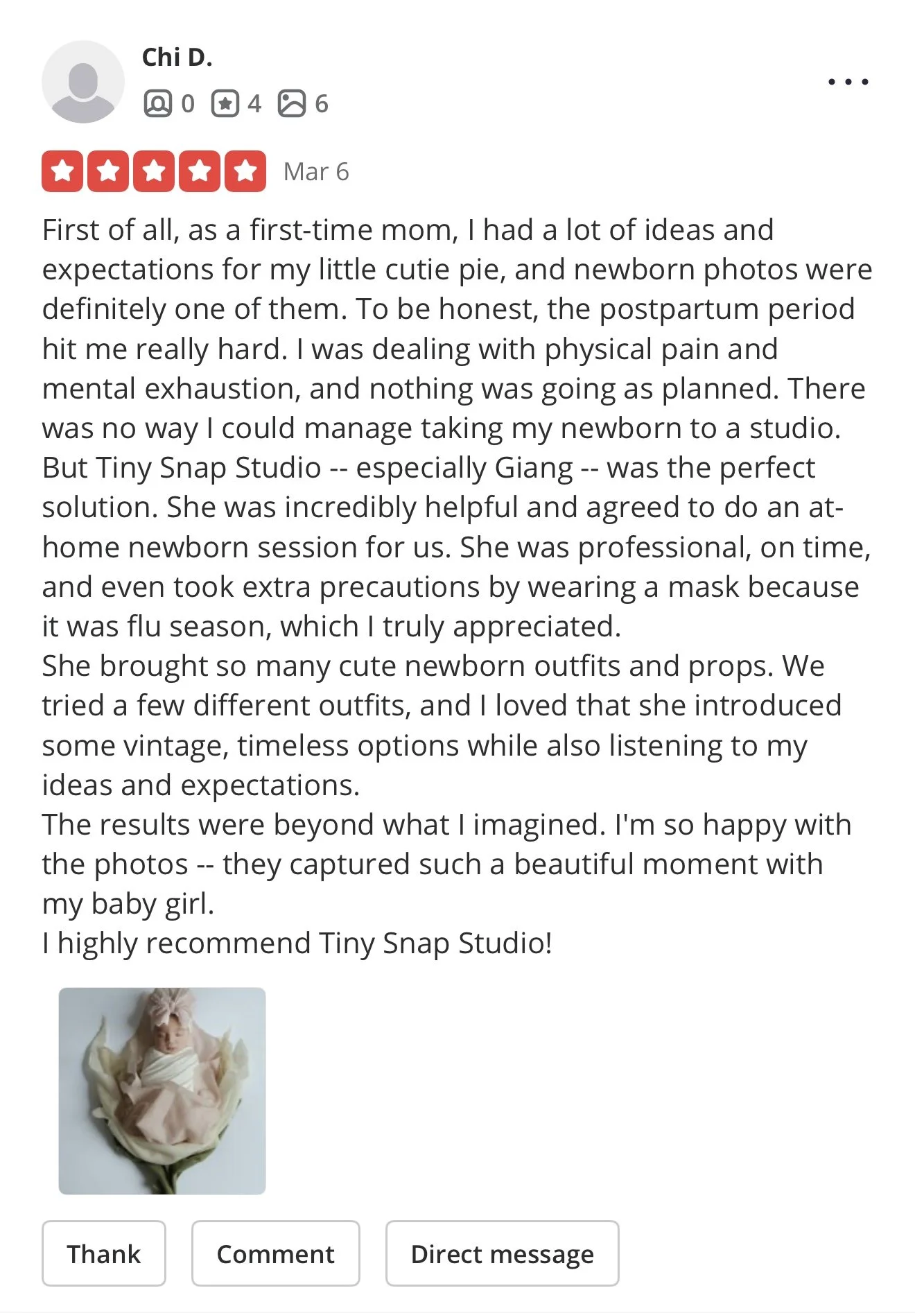 Photo of a baby girl dressed in pink, lying on her back in a cream-colored outfit, with a pink bow on her head.