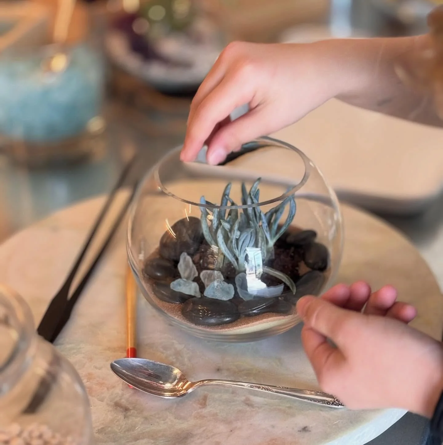Creating at Peridot!  Our potting bench has lots of sand colors, rocks, sea glass, figurines and much more.  Want to schedule an event with us, check out our website for further information.  Link in our bio.