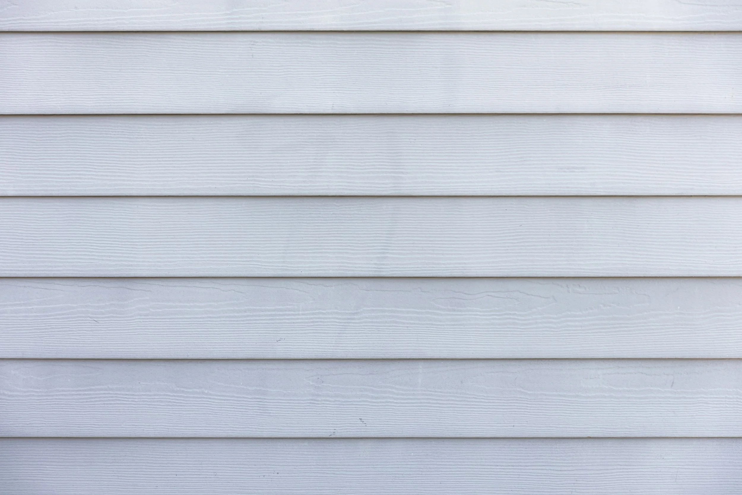 Close-up of white horizontal house siding.