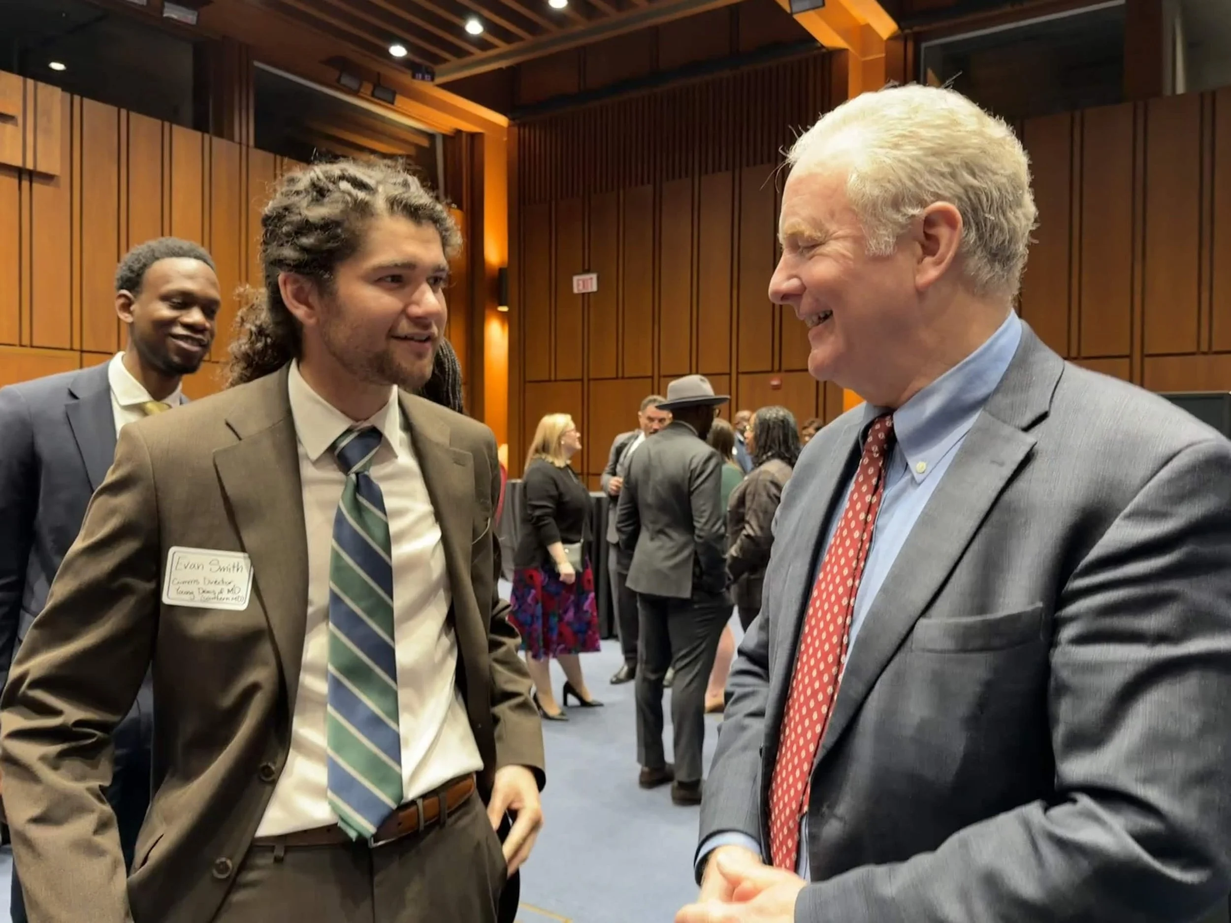 Evan Smith meeting with senior Maryland Senator Van Hollen. Both men are smiling and laughing.