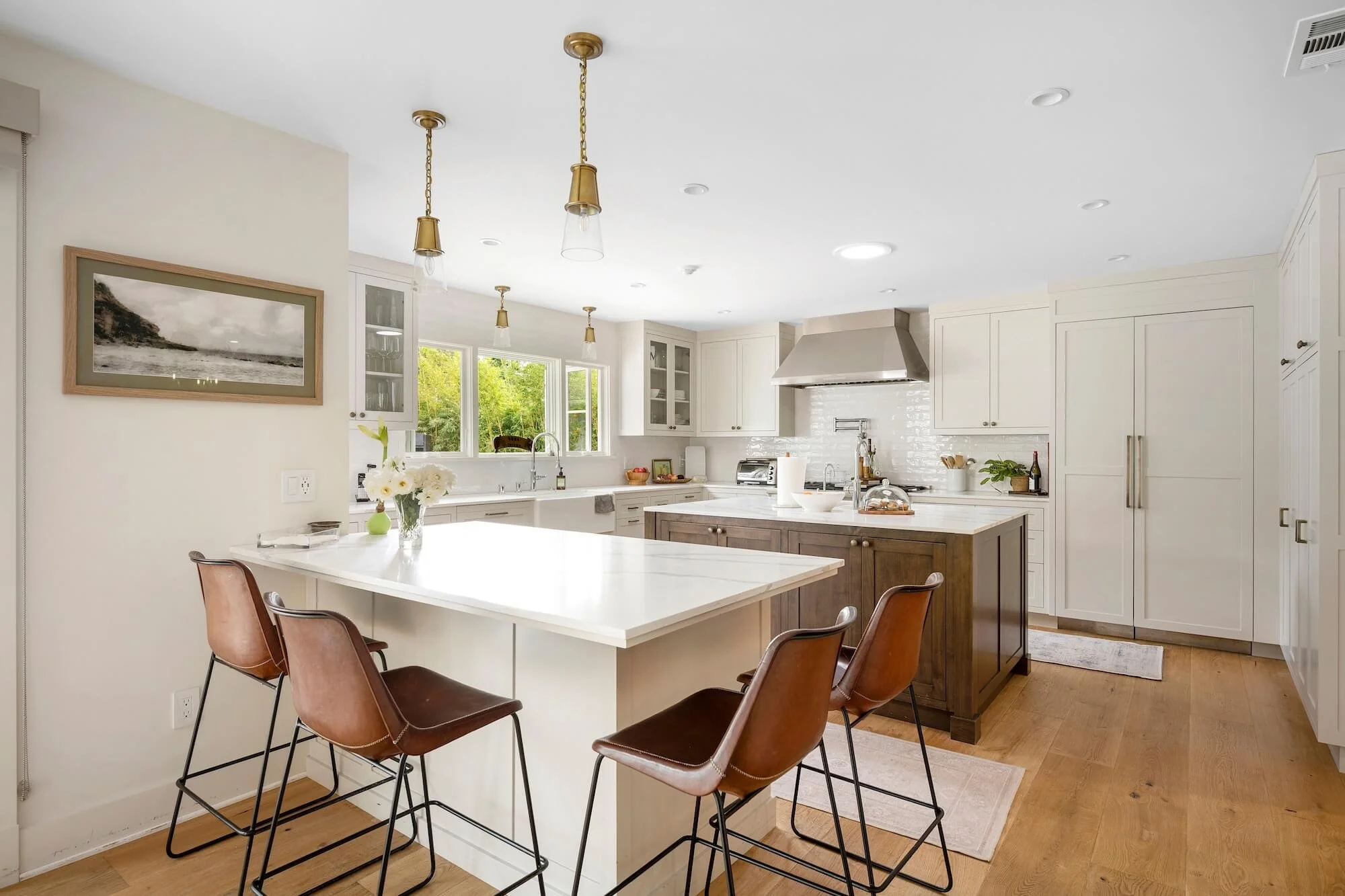 A secondary perspective of the kitchen core highlighting the island and peninsula