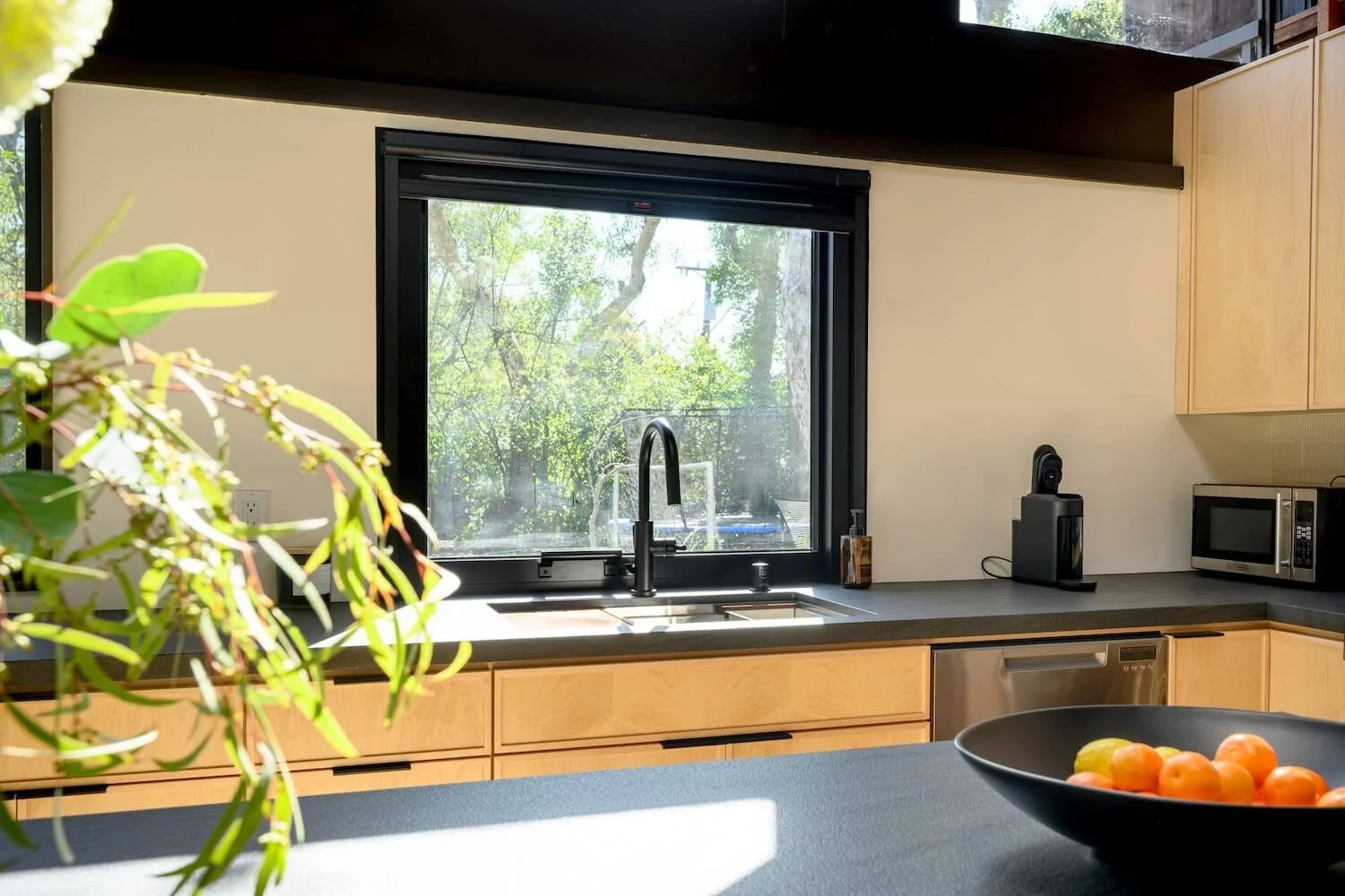 A kitchen interior perspective oriented toward the landscape