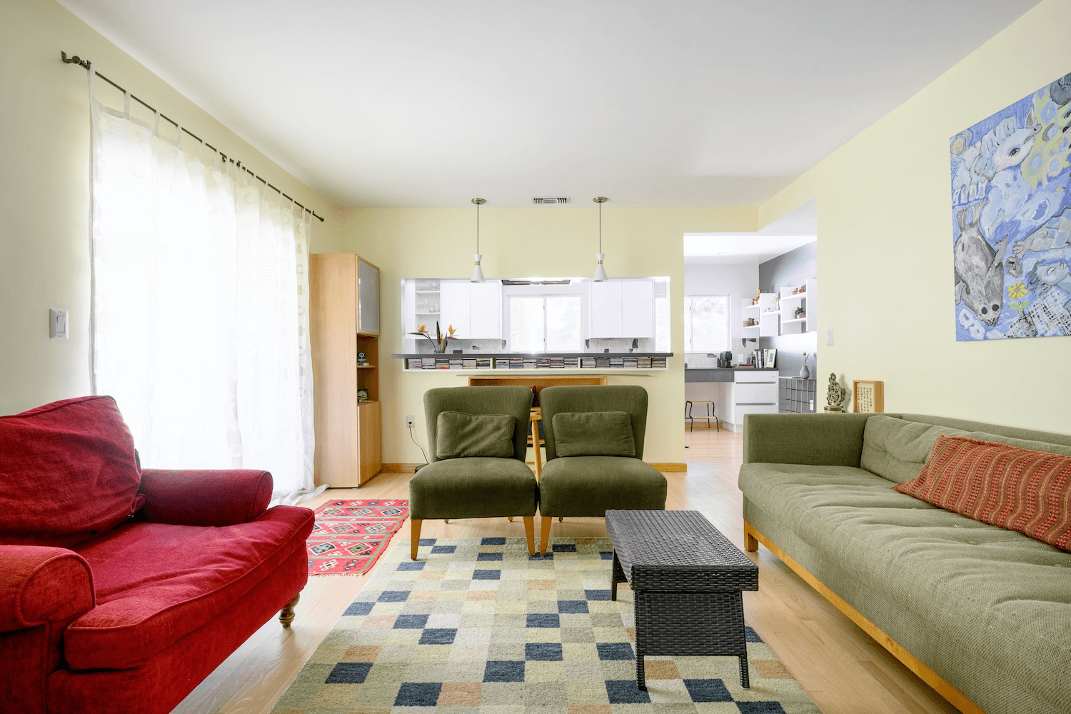 A clear sightline from the family room into the kitchen, emphasizing the home's new transparency and flow