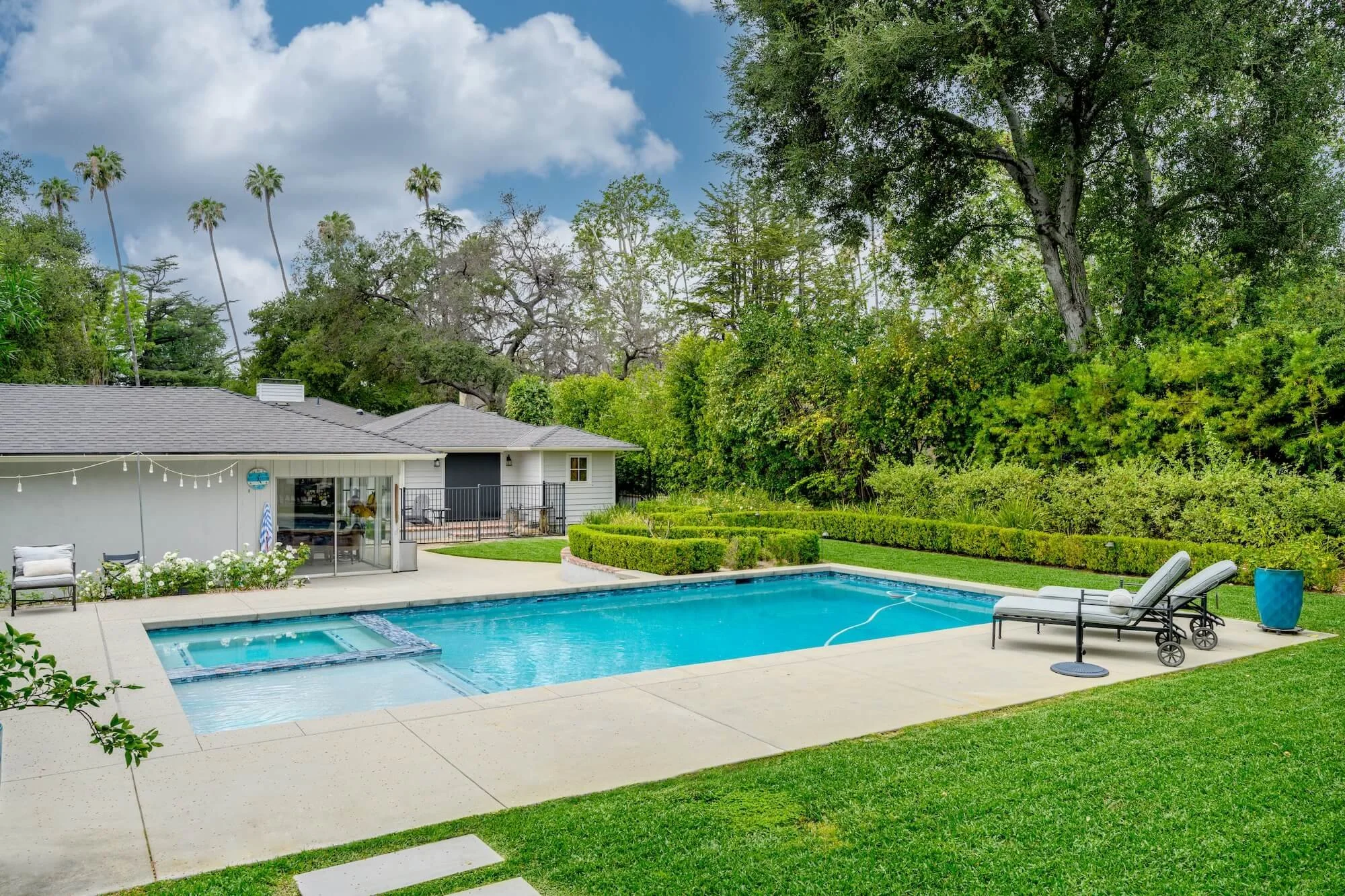 An expansive view of the backyard landscape and pool