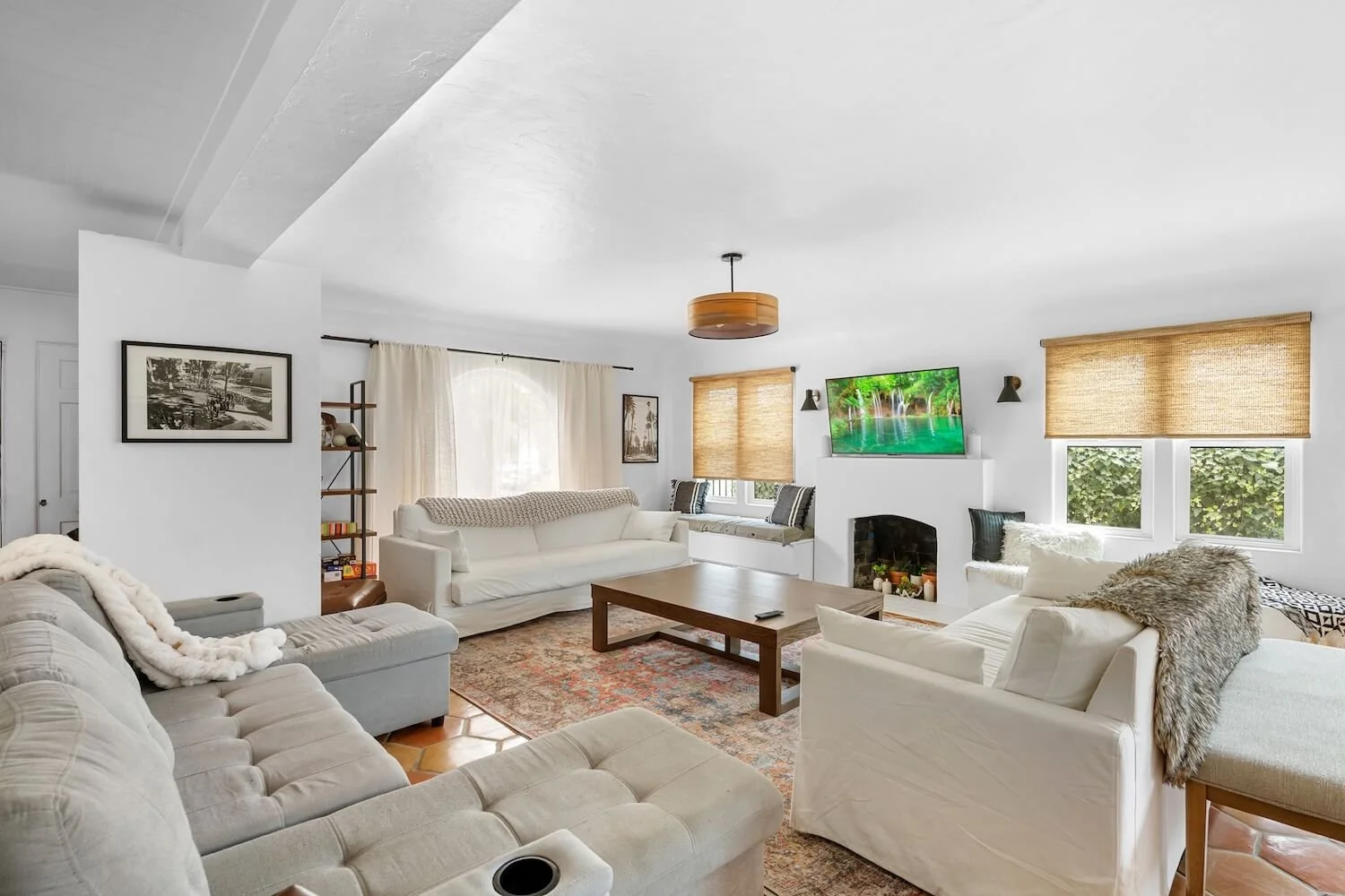 Living area restoration: new windows and a preserved fireplace anchored by Saltillo tiling that flows through the common spaces