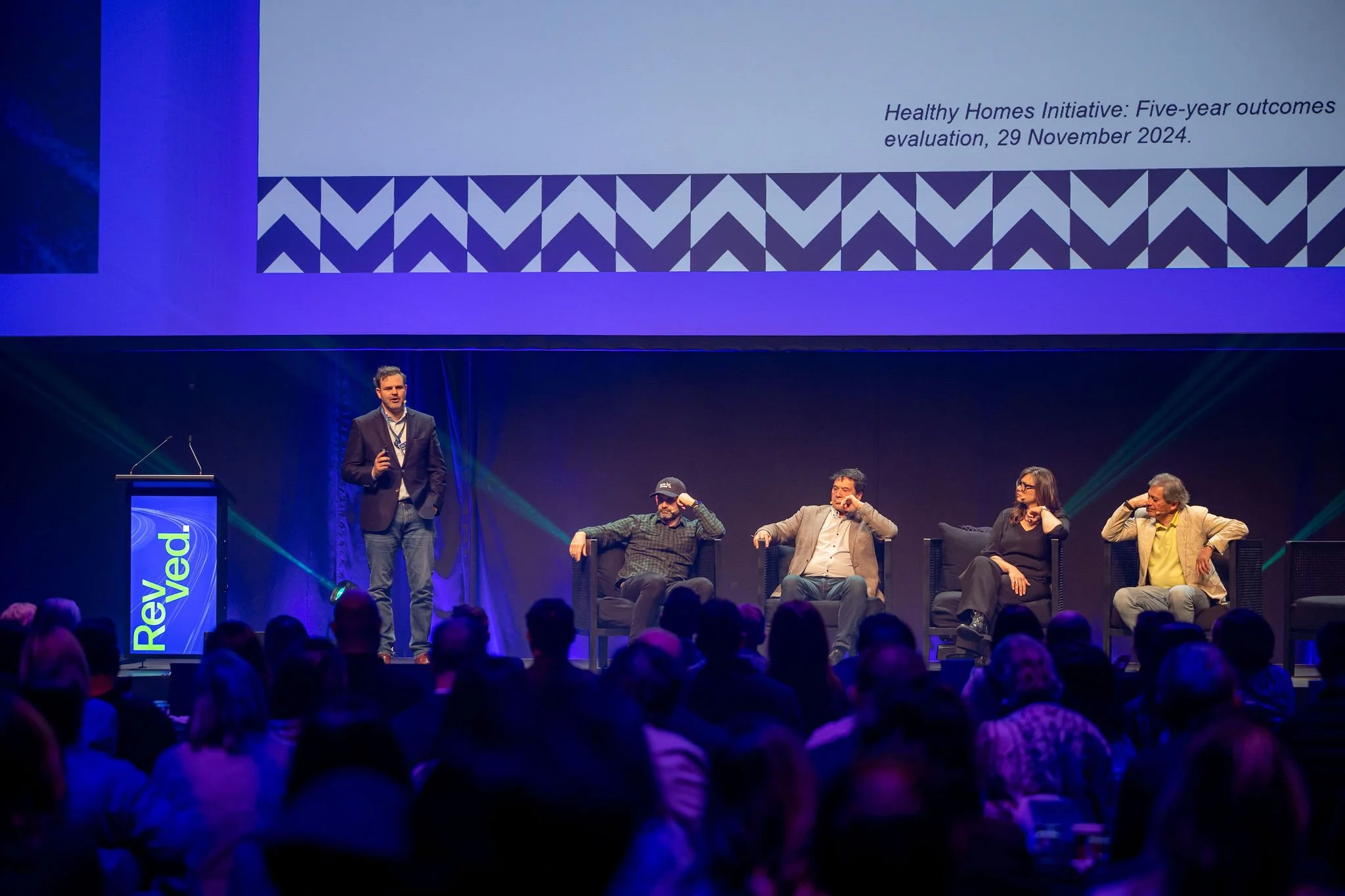 A presenter on stage at Revved 