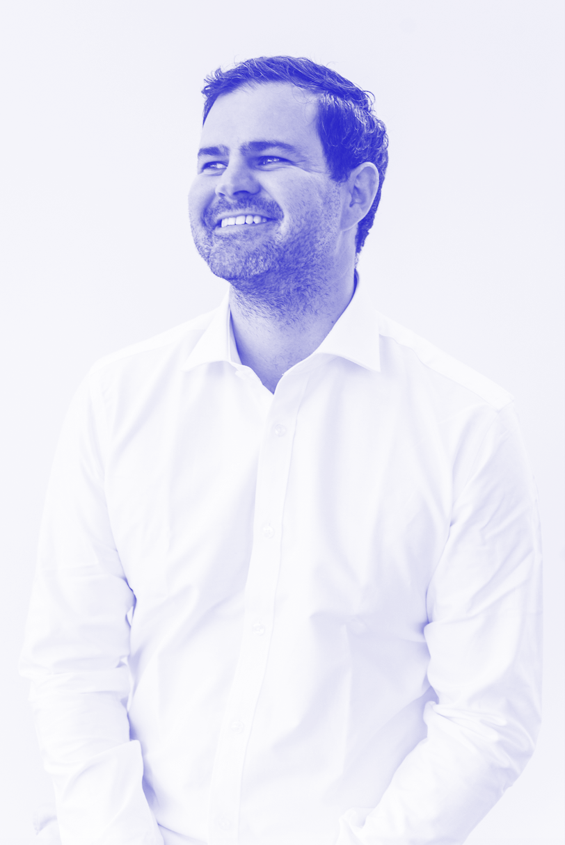 Man smiling, wearing a white shirt, with a light background.