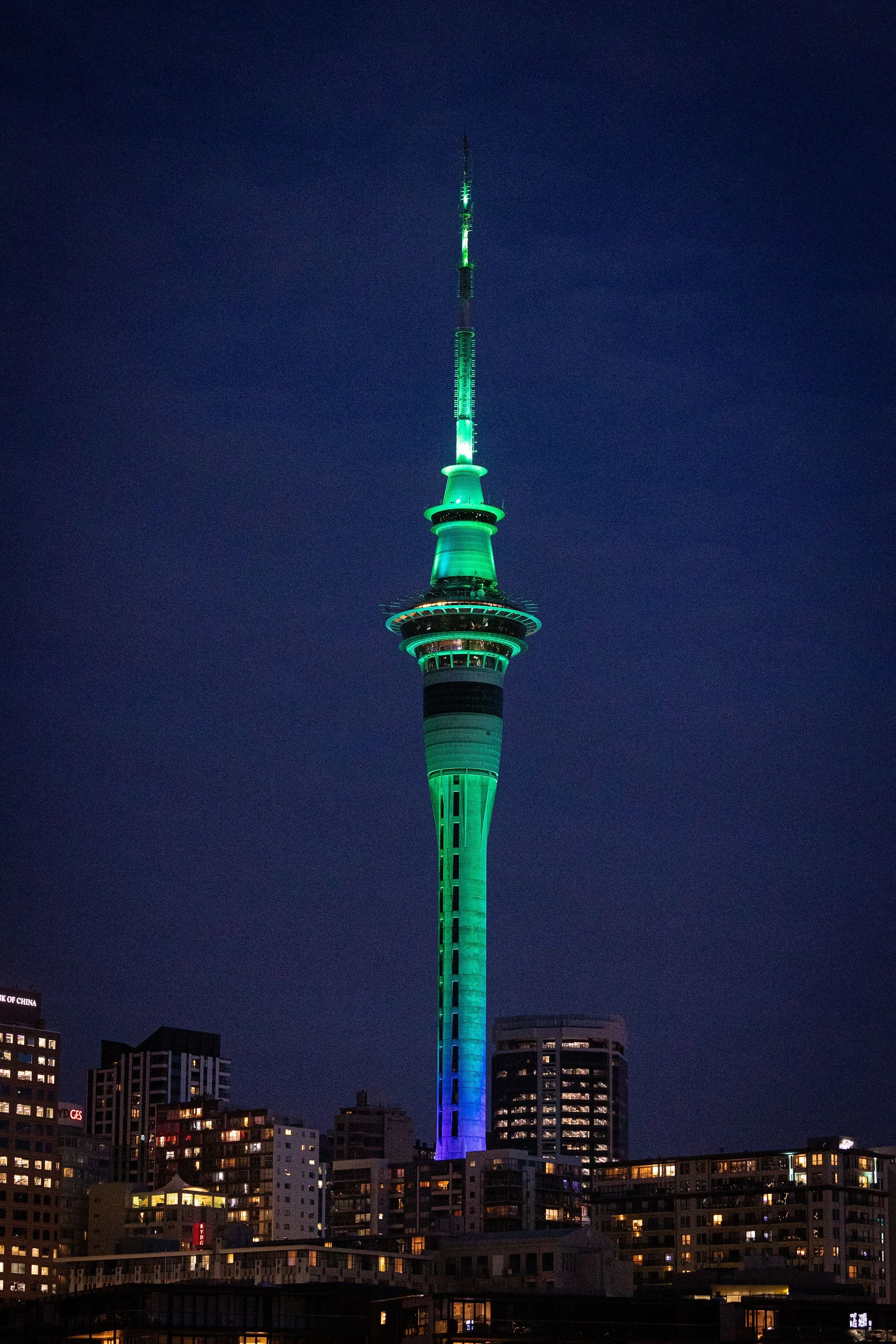 Auckland Skytower illuminated tower with green lighting for Revved
