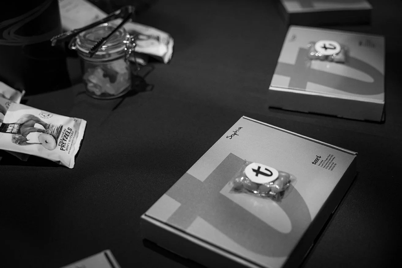 Black and white photo of a table with books, snacks, and a jar with tools on top.