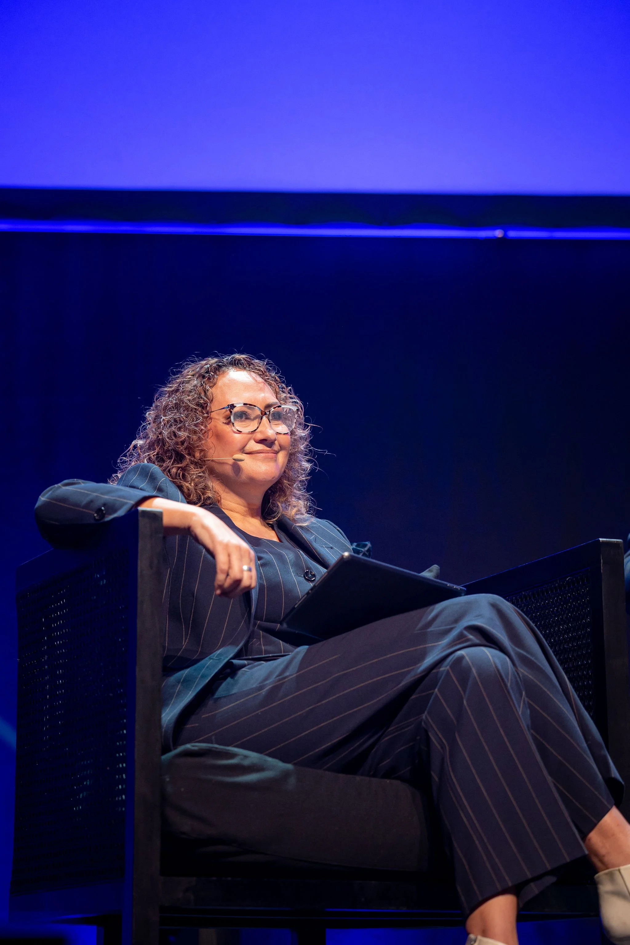 A presenter on stage at the Revved conference