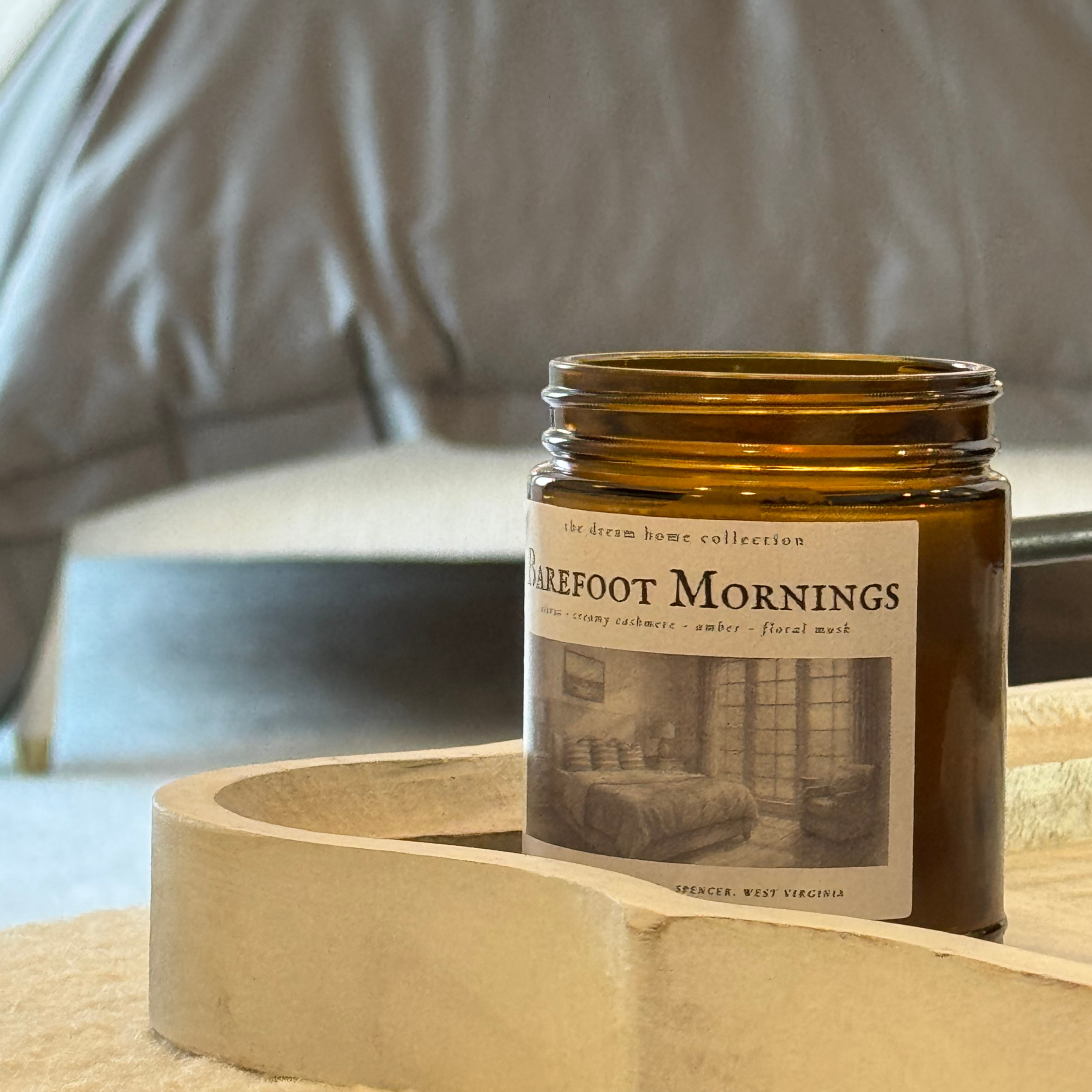 barefoot mornings soy candle in bedroom.png