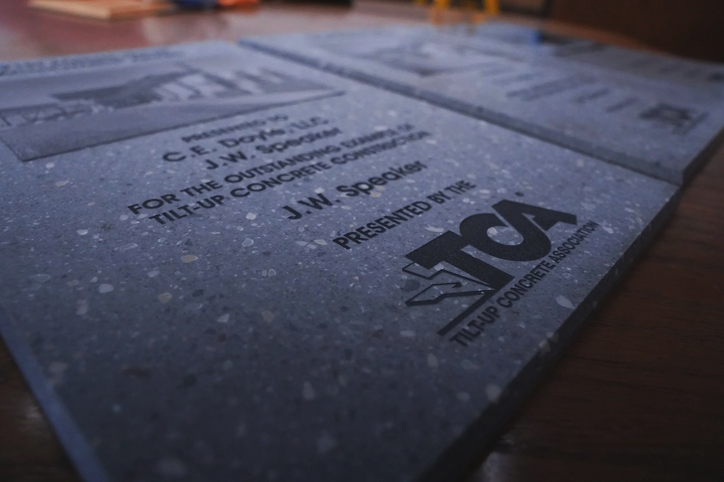 Close-up of an award plaque with text and a logo from the Turfgrass Environmental Quality Project.