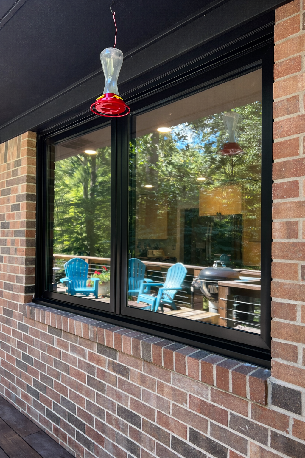 Hummingbird feeder by the window.png