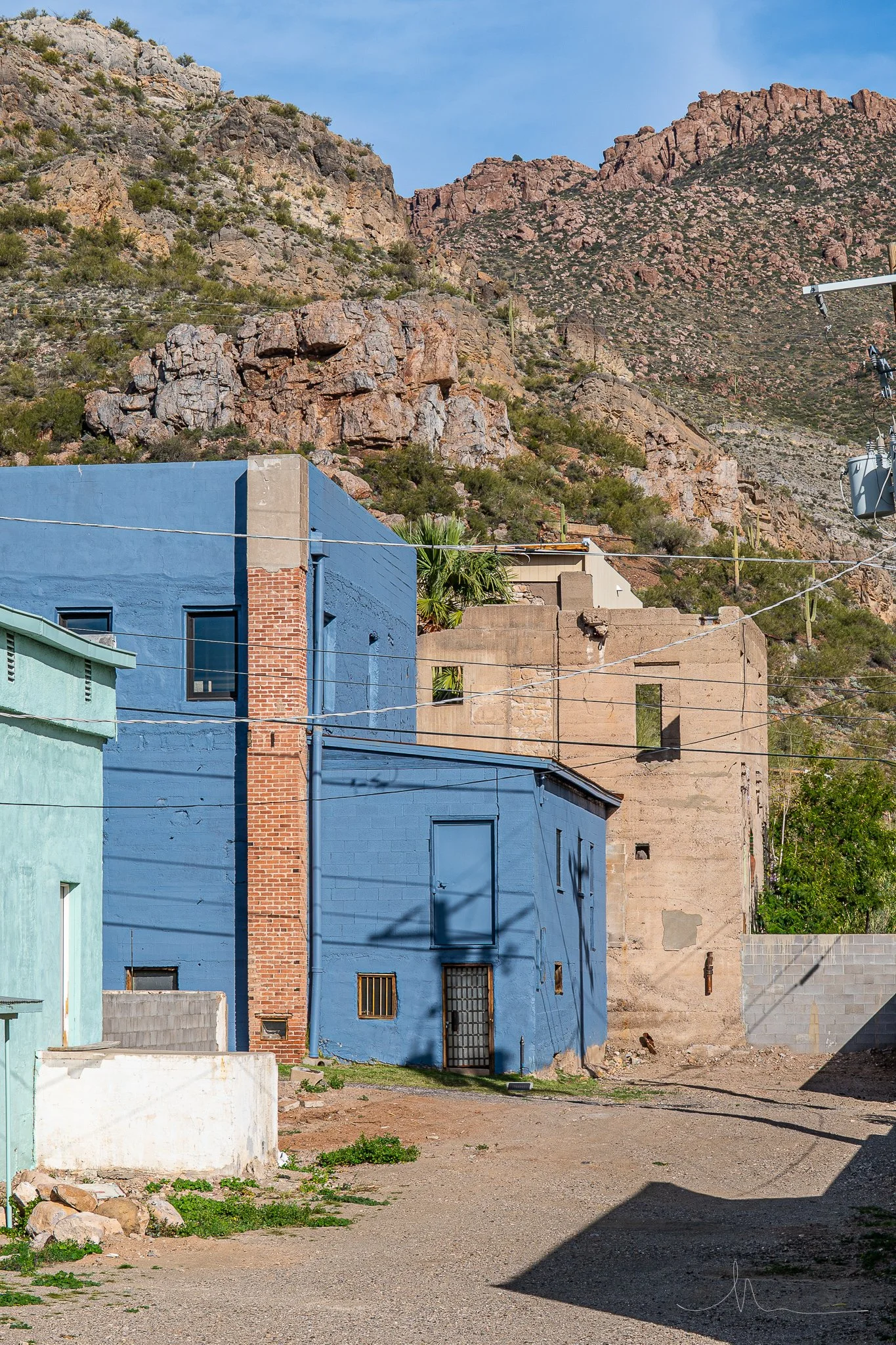 Colorful buildings with a mountain backdrop and clear blue sky.