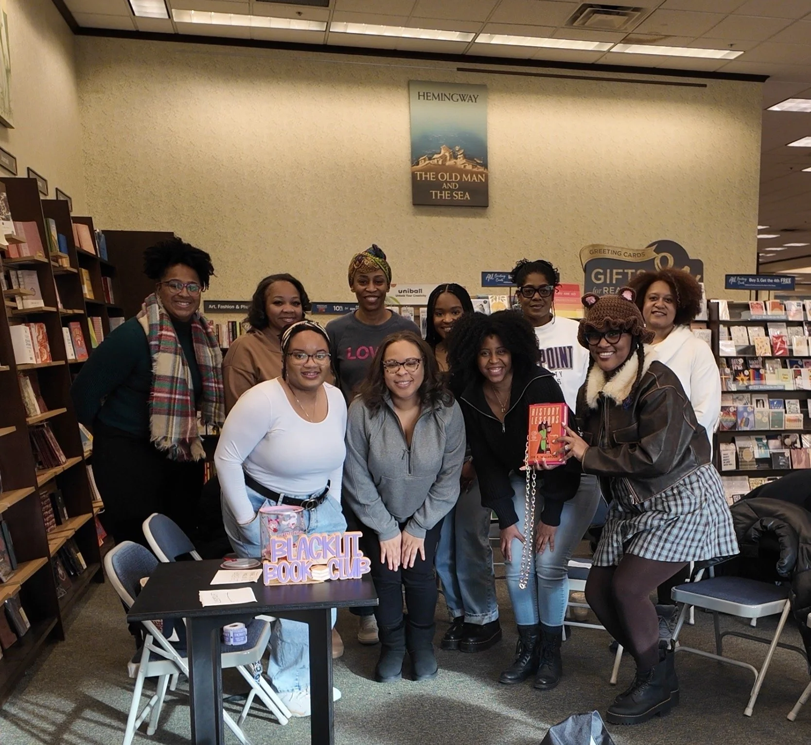 Black Lit. book club members  gathered in a bookstore for a book club meeting. 