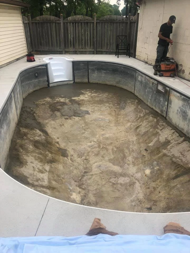 Empty inground swimming pool that has been prepped for a new liner.