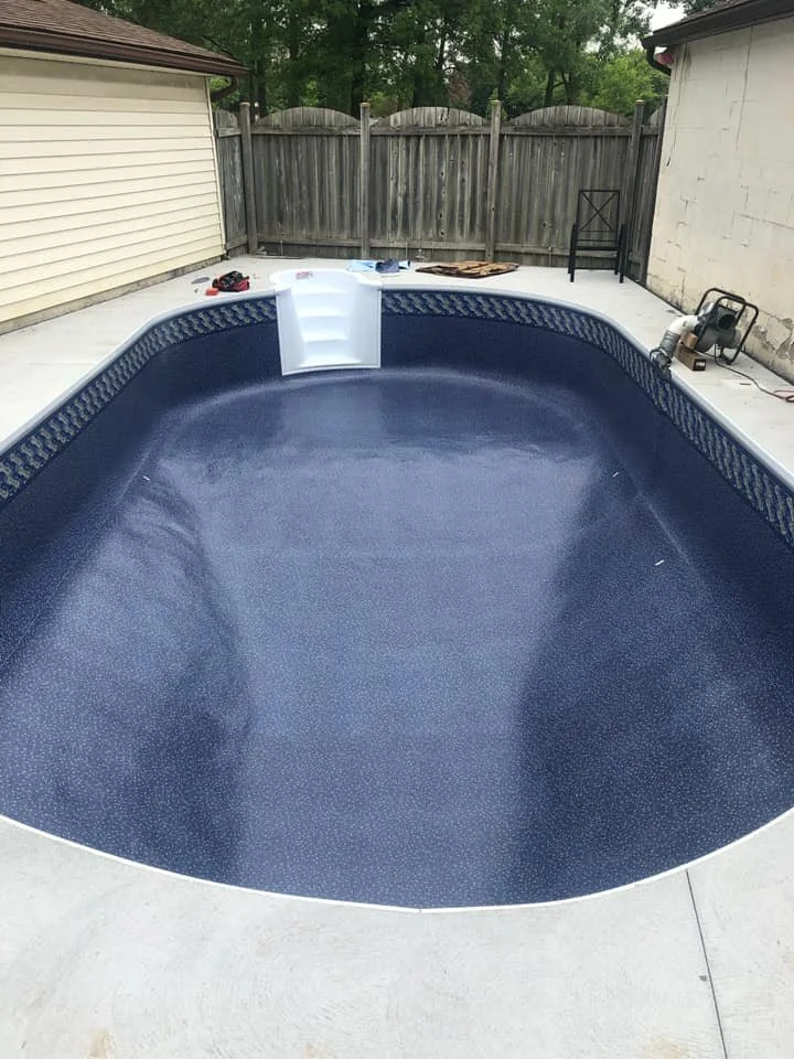 Empty in-ground swimming pool with a new liner.