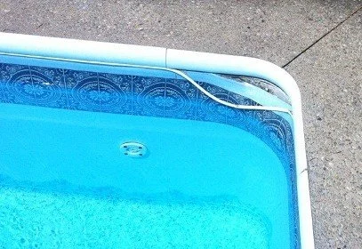 Close-up of the corner of a swimming pool liner that has bead separation.