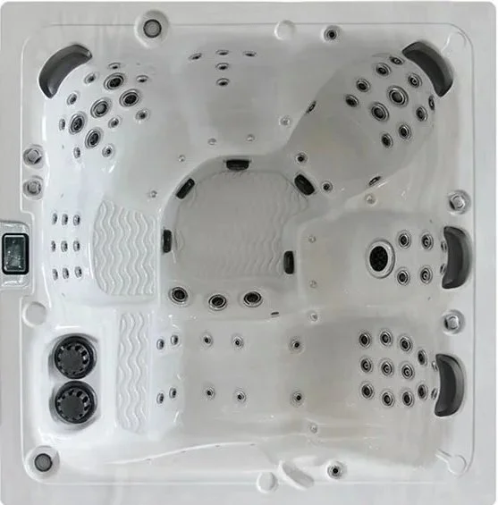 Top view of a white hot tub with multiple jet nozzles and control panel.