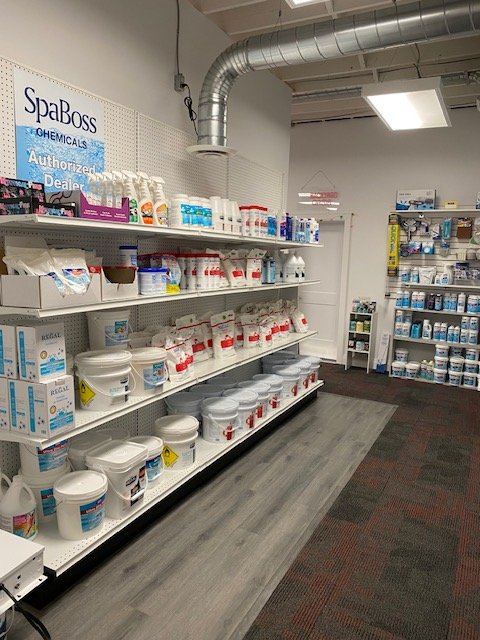 Shelves stocked with various pool chemicals and supplies at a pool store in WIndsor.