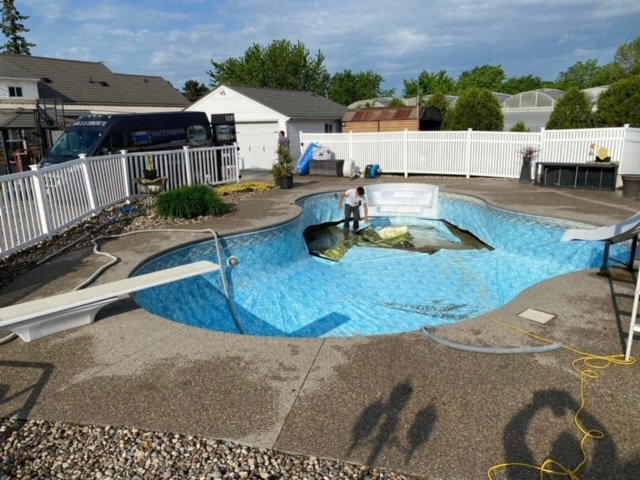 Old pool liner being prepped for replacement.
