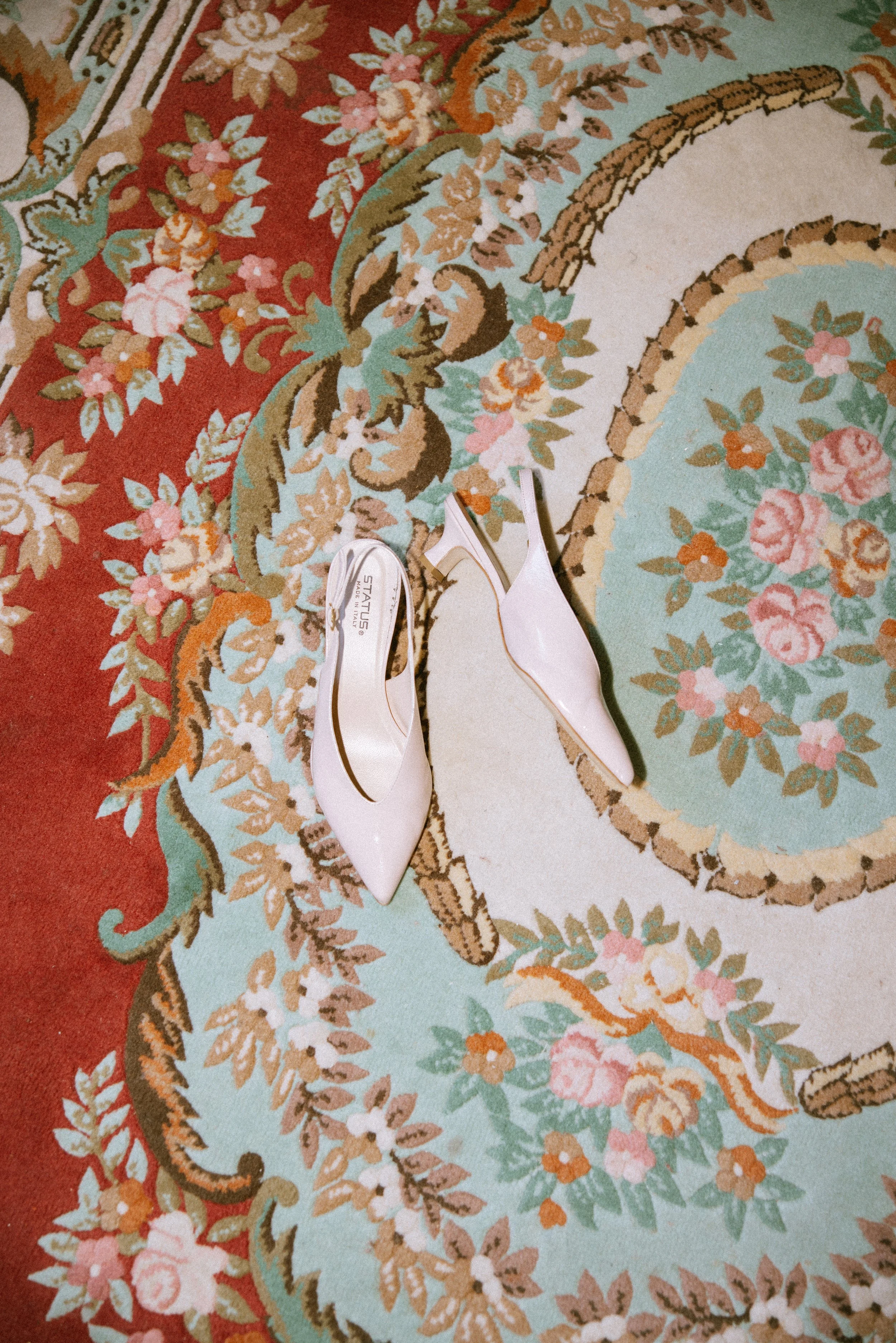 Wedding shoes shot on coloured tapestry carpet