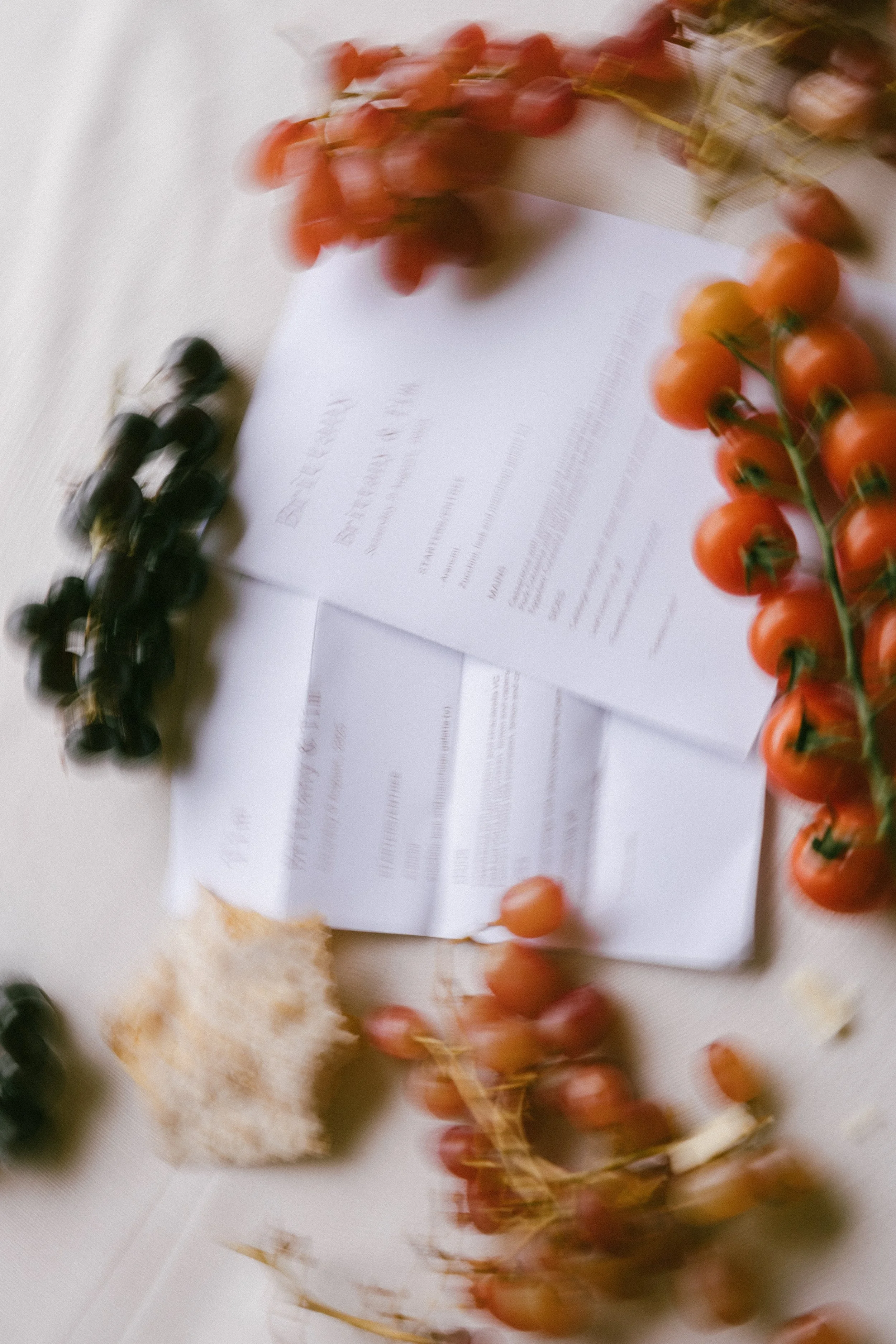 Styled cherry tomatoes and wedding invite