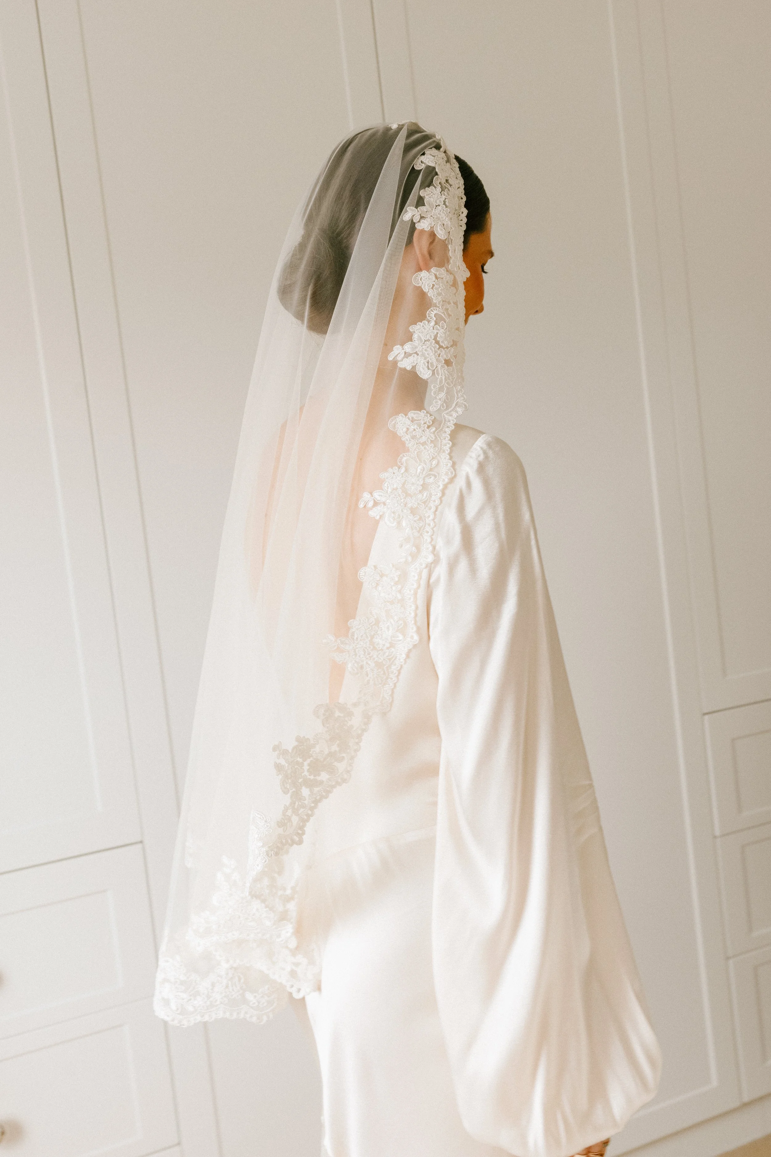 Bride wearing long lace veil