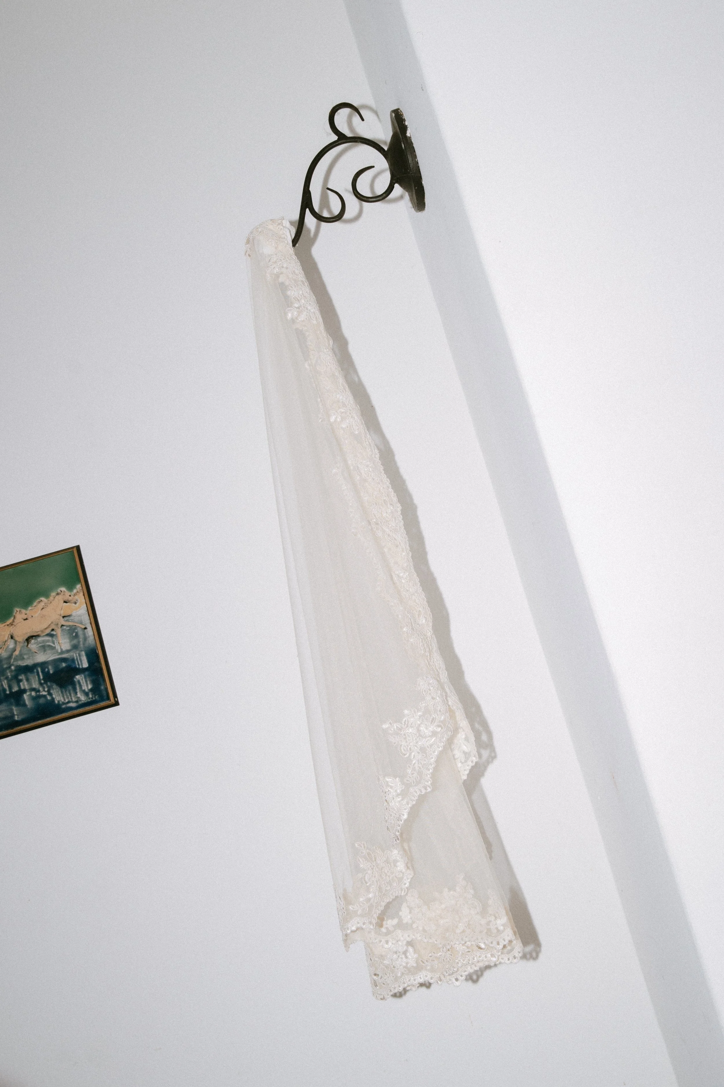 Veil hanging on antique brass wall mount
