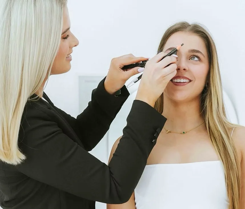 Cosmetic tattoo trainer demonstrating powder brow mapping technique