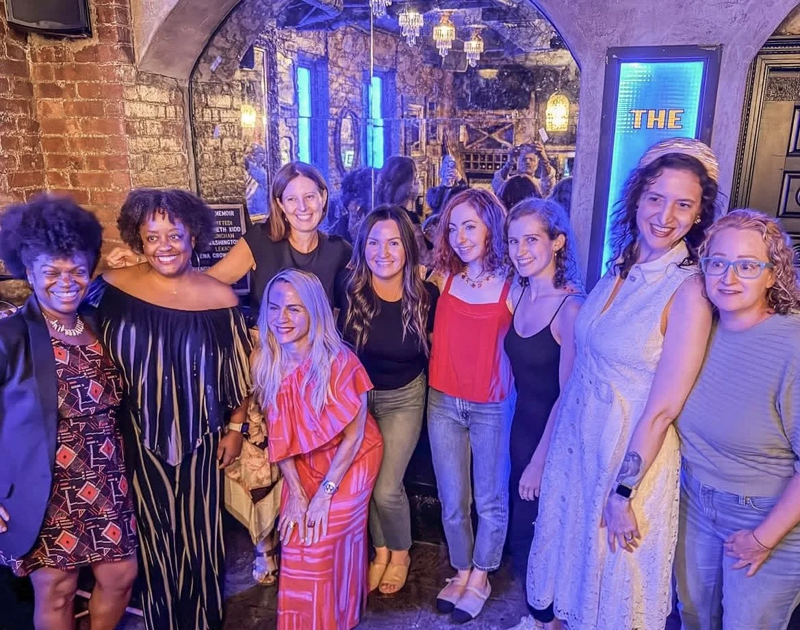 The readers stand together at the front of the bar.