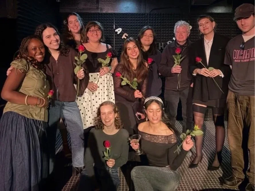 Jacqueline smiles with the fellow readers that night, including her professor Robert Polito.