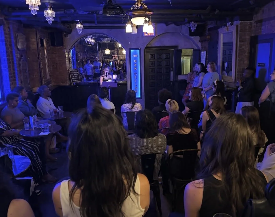 The crowd listens to Jacqueline reading.