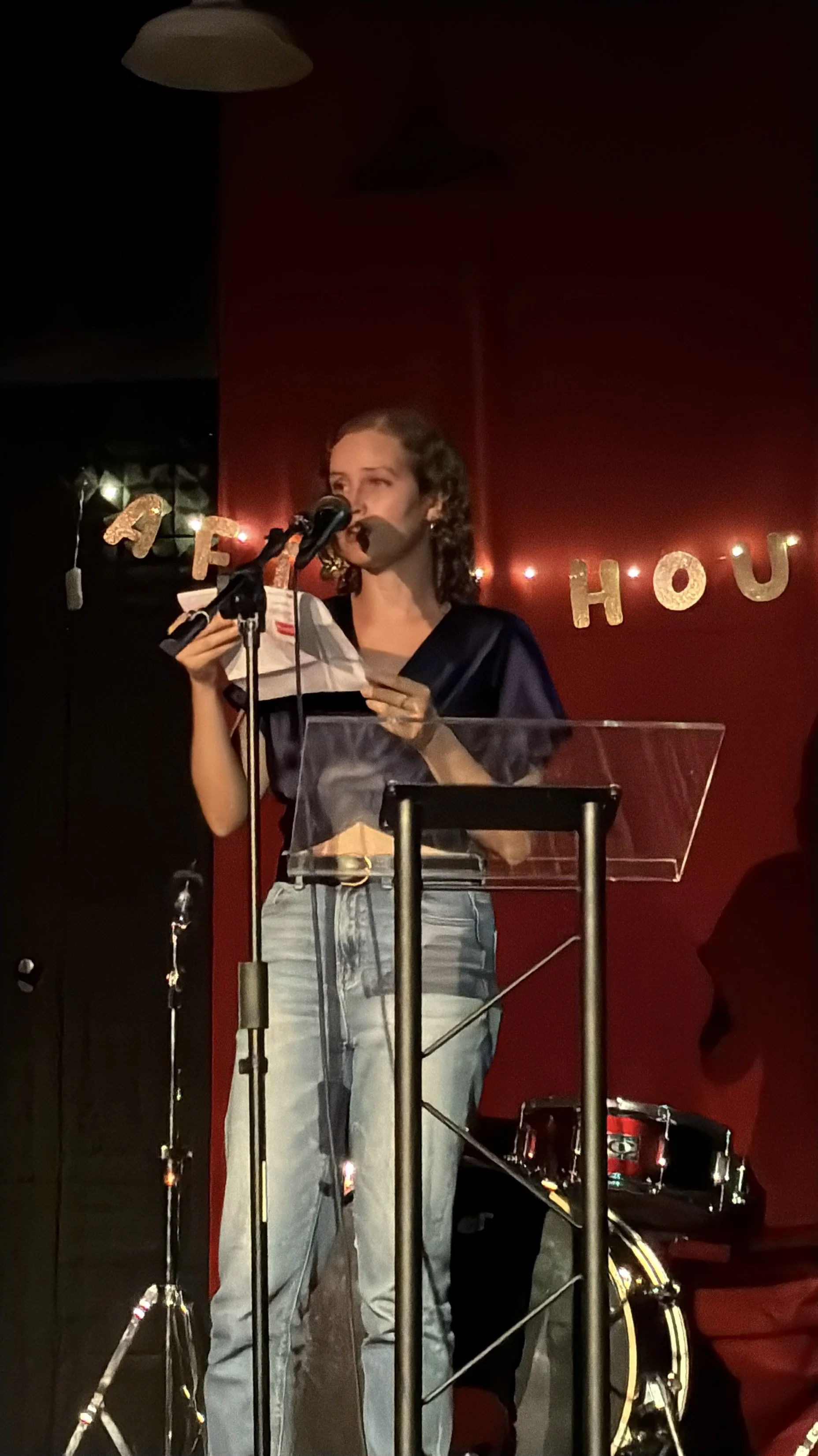 Jacqueline reads at the front of the bar.