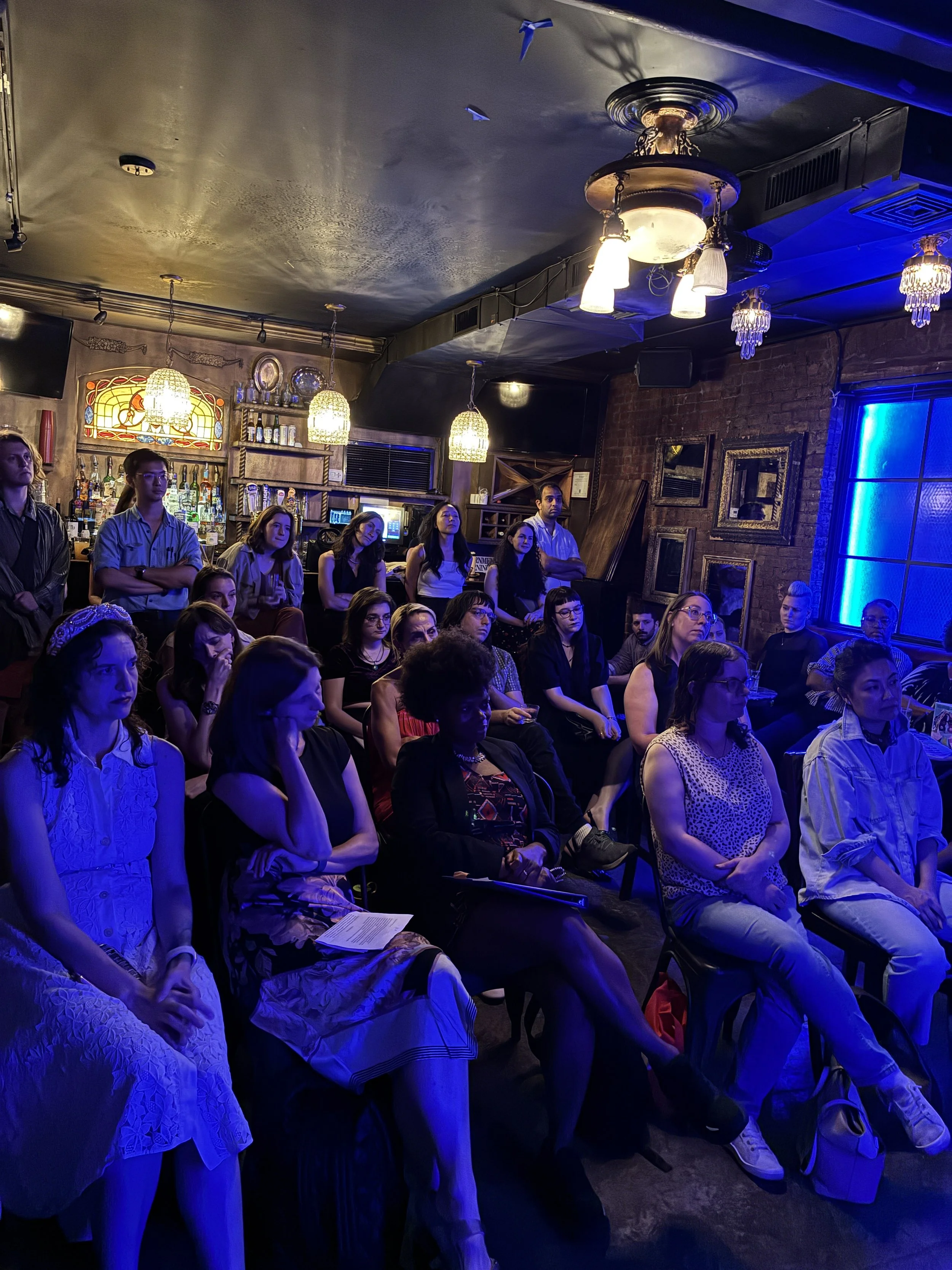 The crowd listens to Jacqueline read.