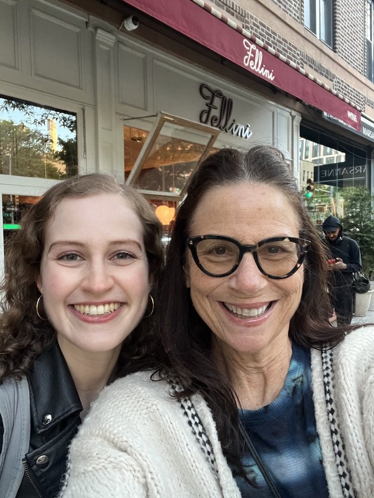 The author and her older friend smile outside a coffee shop.