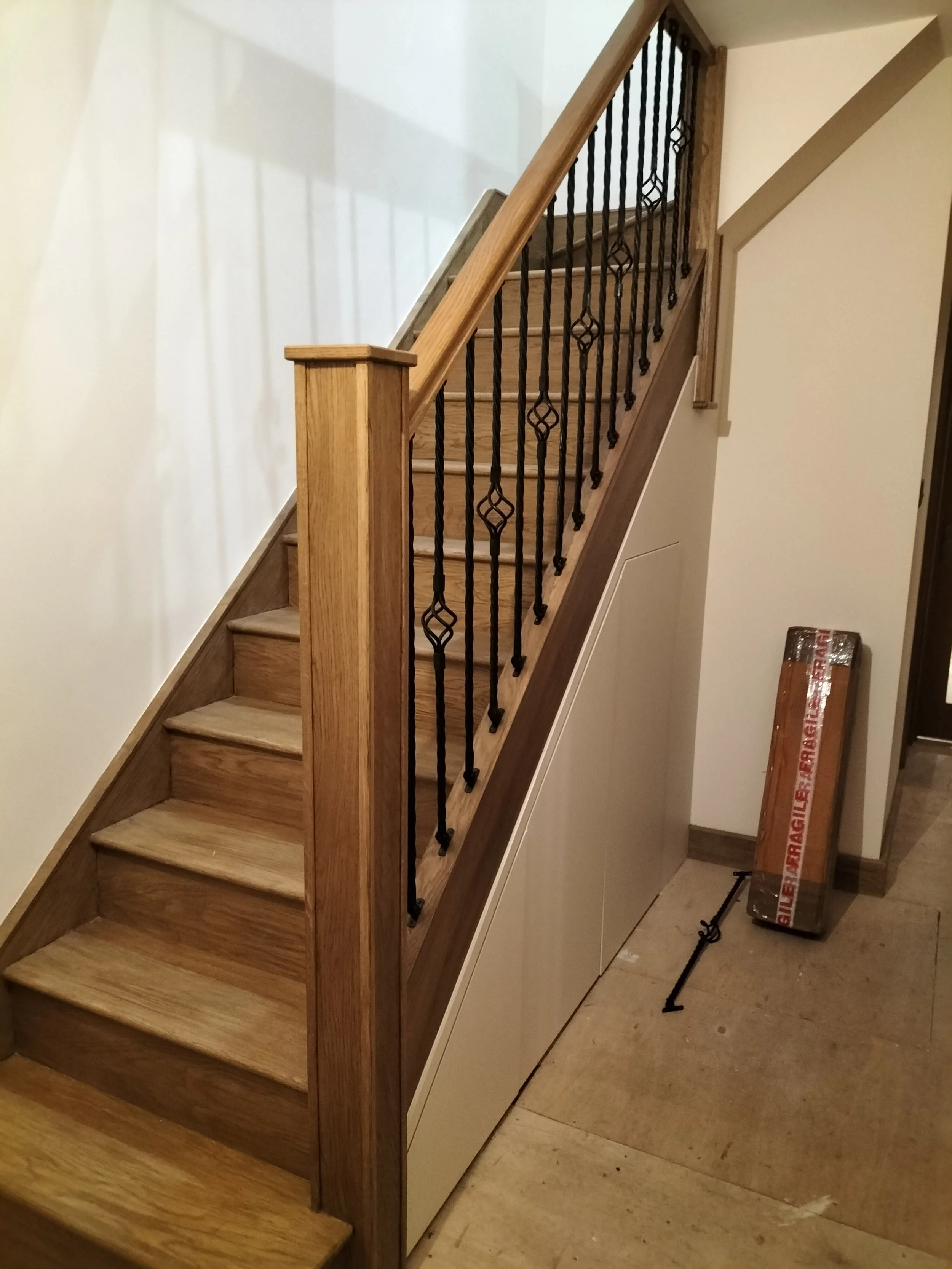 Renovated staircase . Cladded in oak with metal spindles