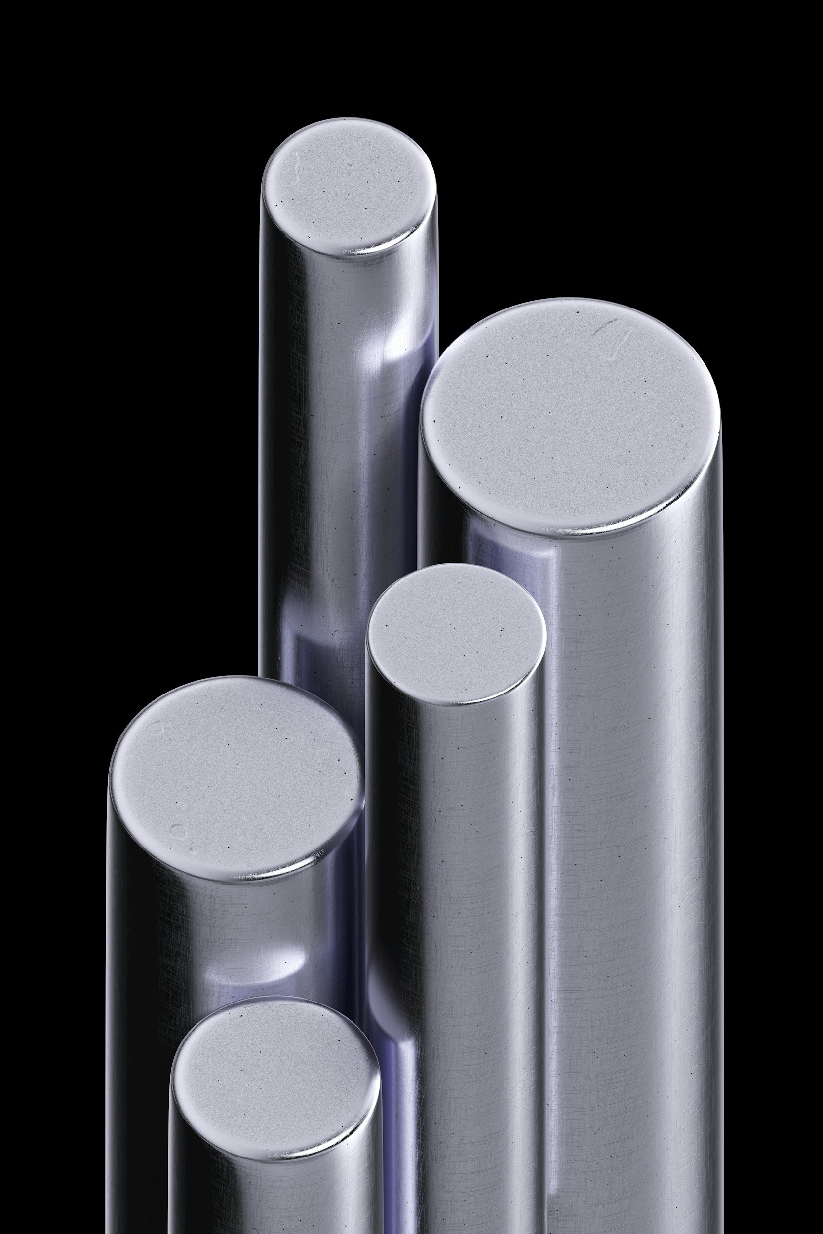Close-up view of five cylindrical metal rods with reflective surfaces against a black background.