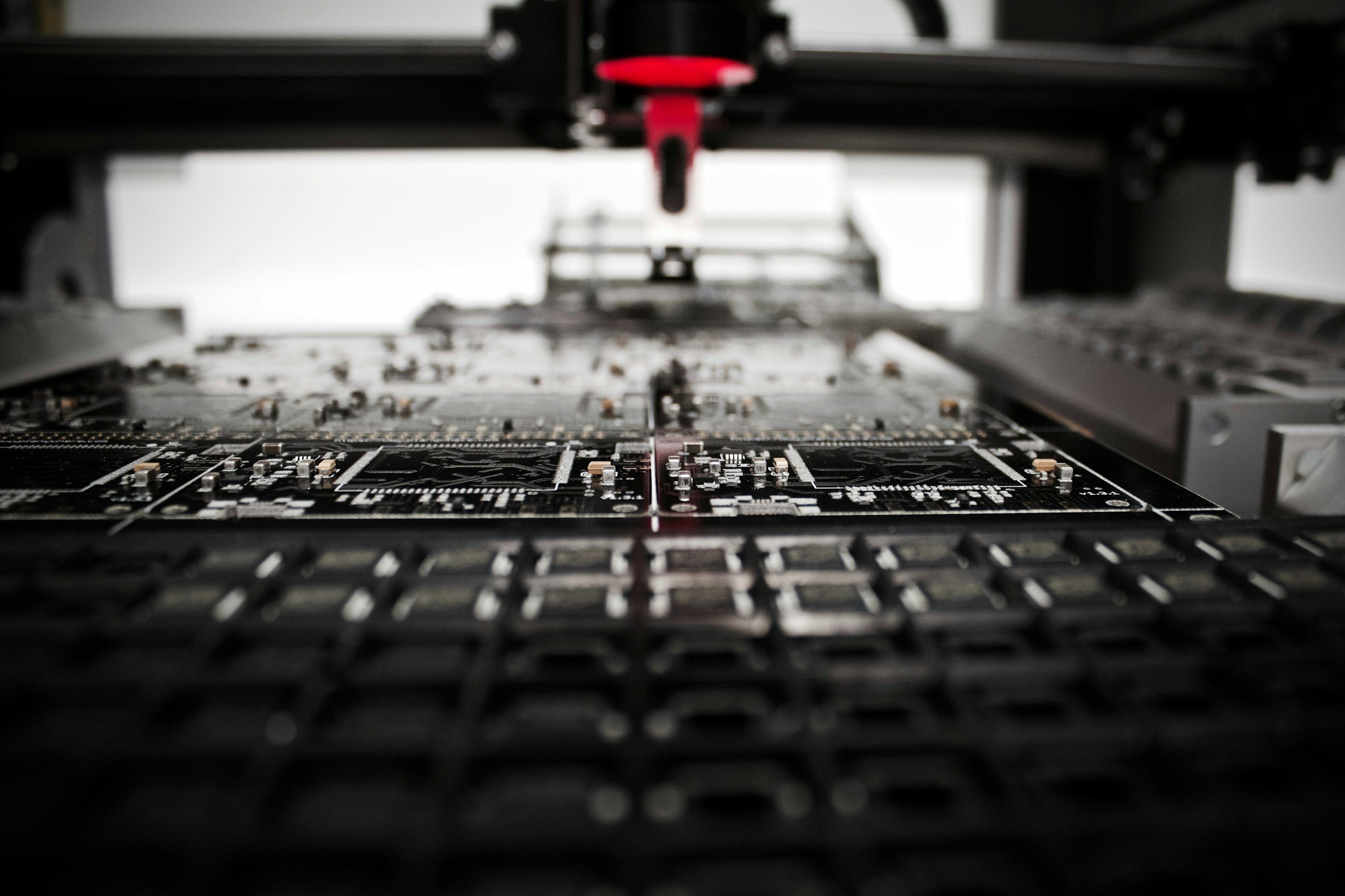 Close-up view of a circuit board assembly line in a manufacturing facility.