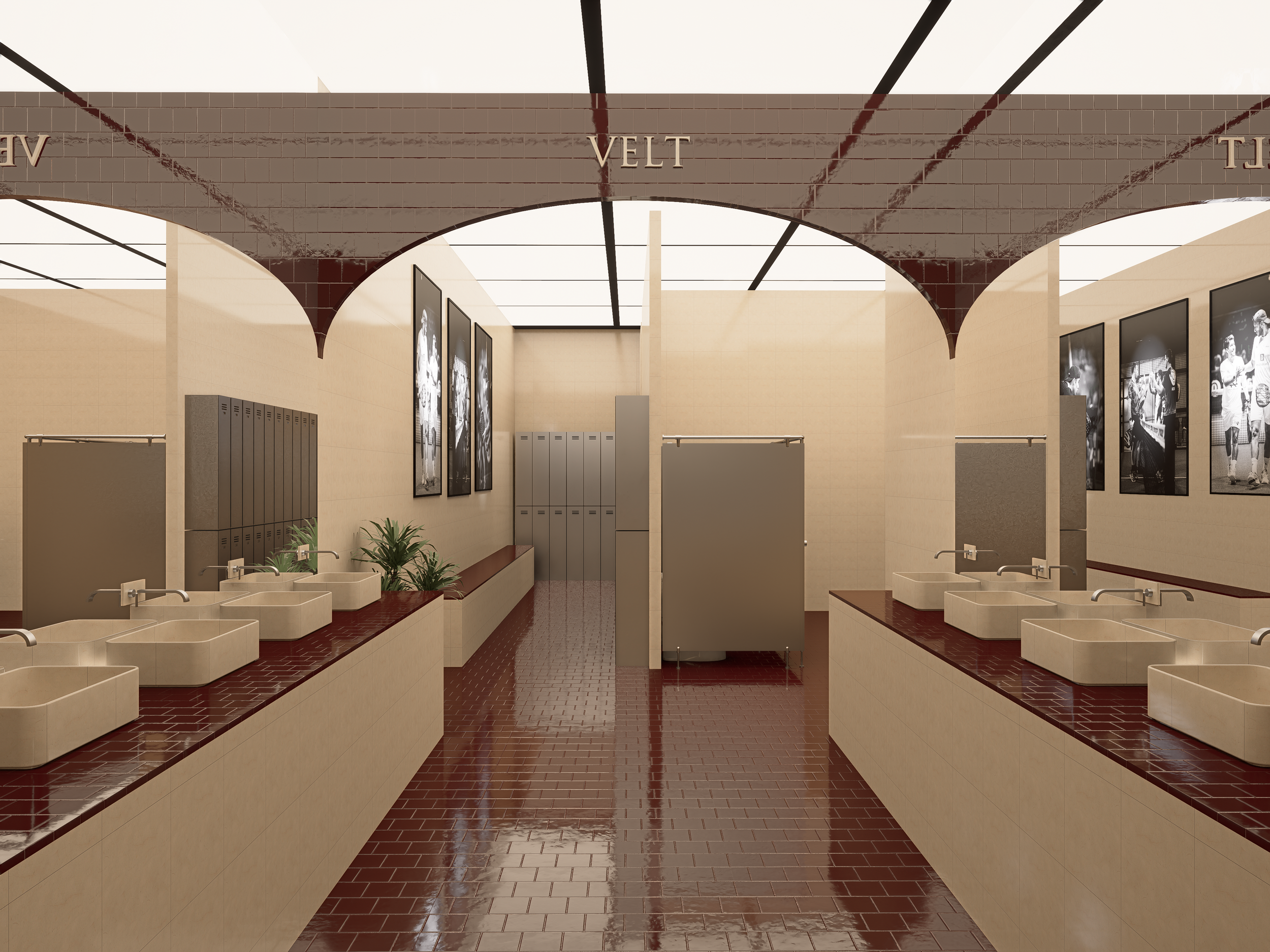School locker room with multiple sinks, lockers, and sports posters on beige walls with red tile floors.