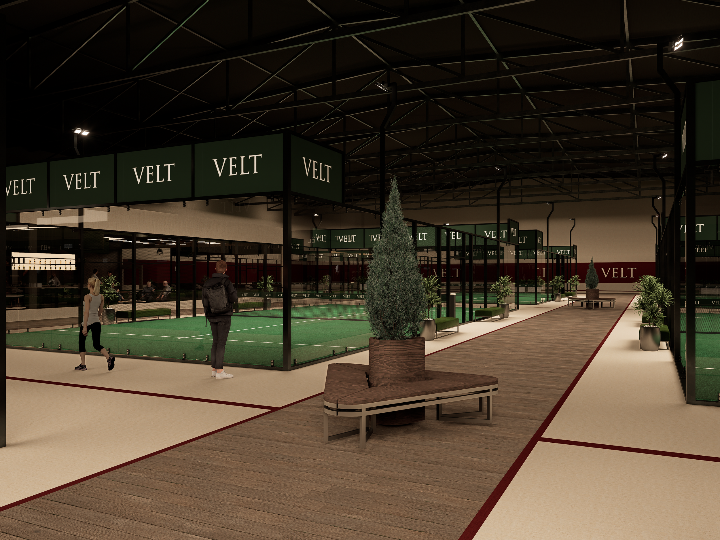 Indoor tennis or sports facility with green courts, seating, and potted plants, featuring a modern industrial ceiling and multiple signs saying VELT.