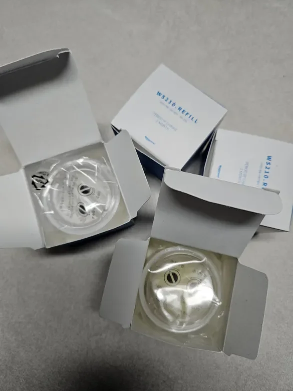 Two small boxes of WS310 refill with circular sterile filters inside.