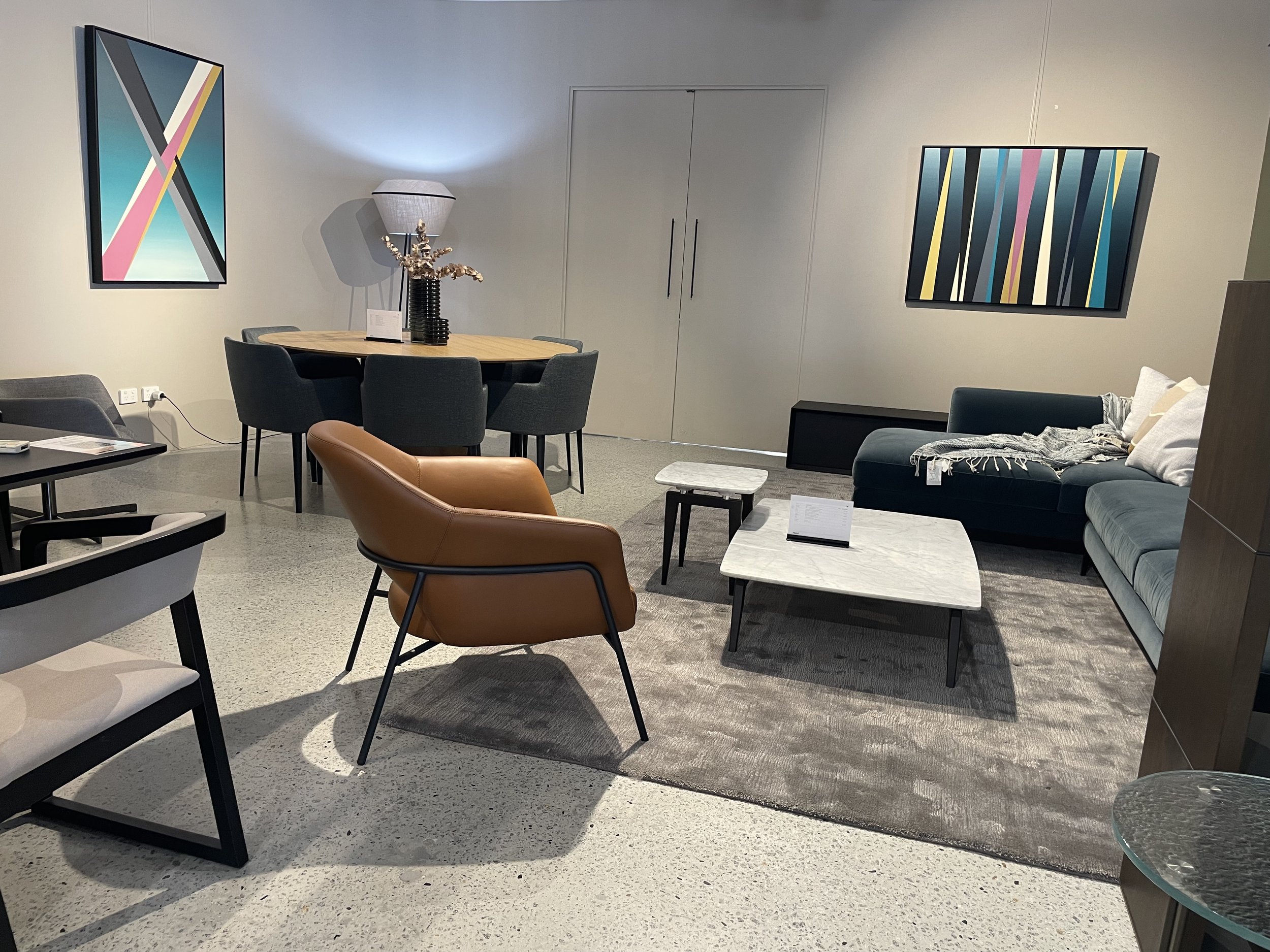 Interior of a modern furniture store with Studio Jacobson Artwork on the walls.